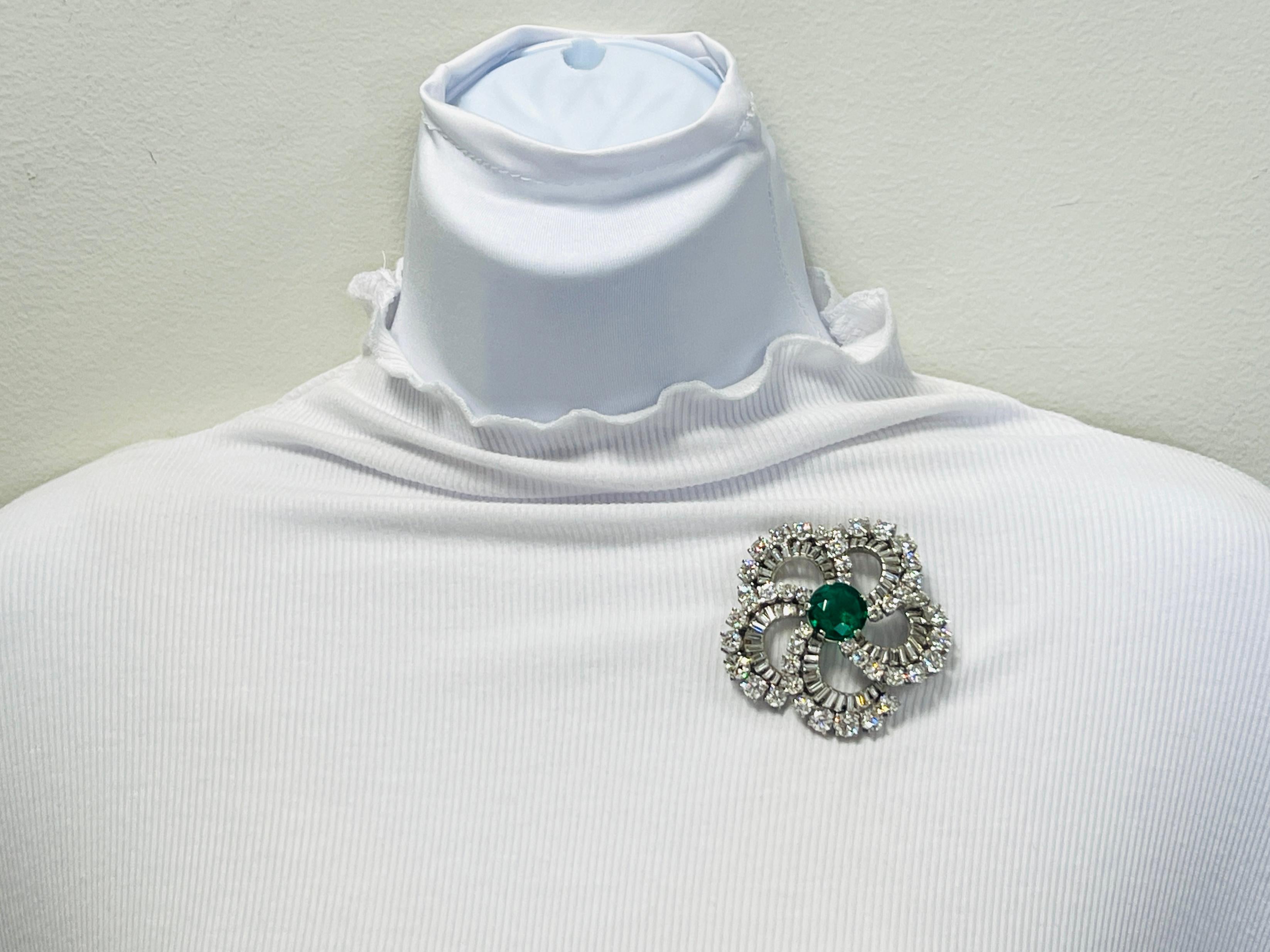 Stunning 11.01 ct. natural Colombian emerald round with good quality, white, and bright diamond rounds and baguettes.  Handmade in 18k gold.  Original box is included.

