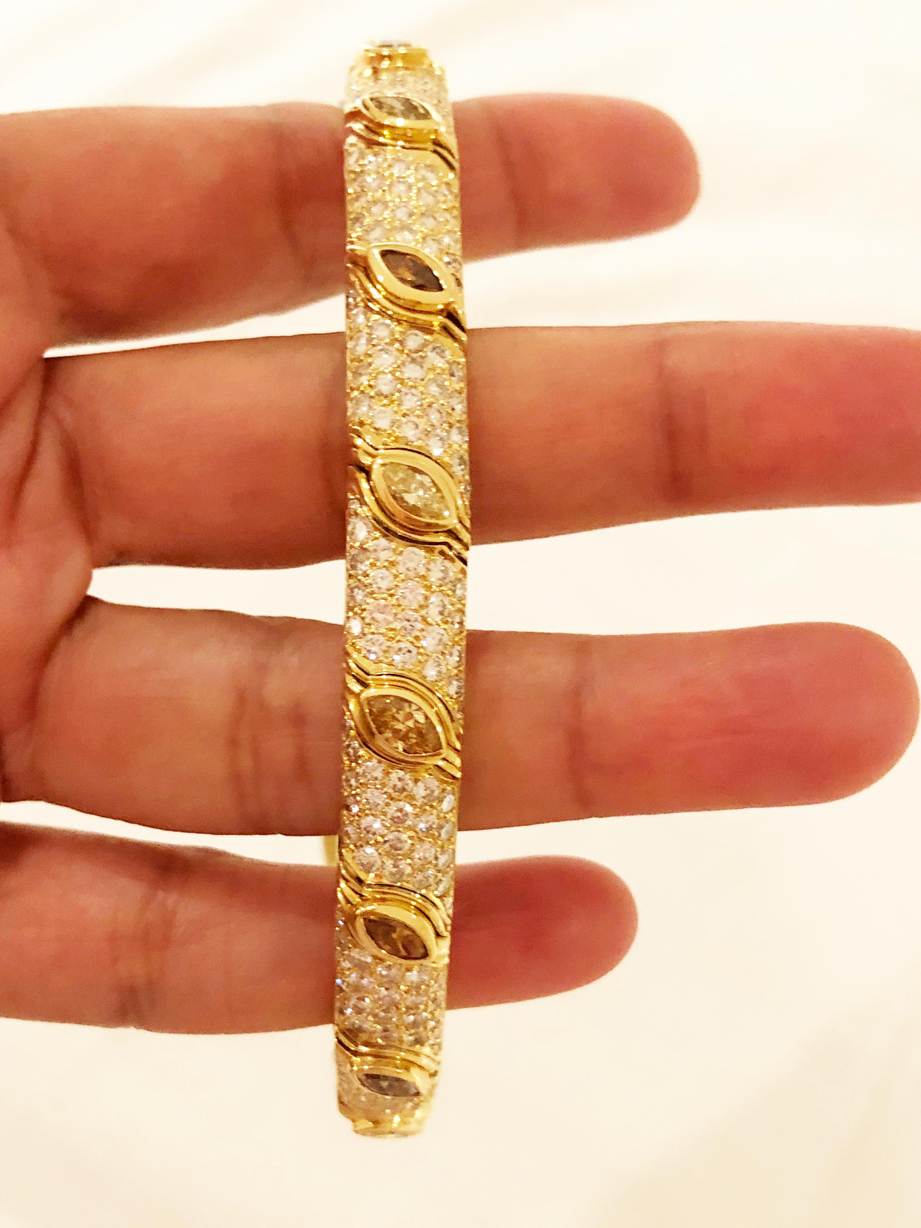 Gorgeous estate Bulgari multi color marquise and round diamond bracelet in 18k yellow gold.  Unique setting with flexibility and classic Bulgari design, this bracelet is perfect for stacking or wearing on it's own.  Multicolor diamonds weigh 4