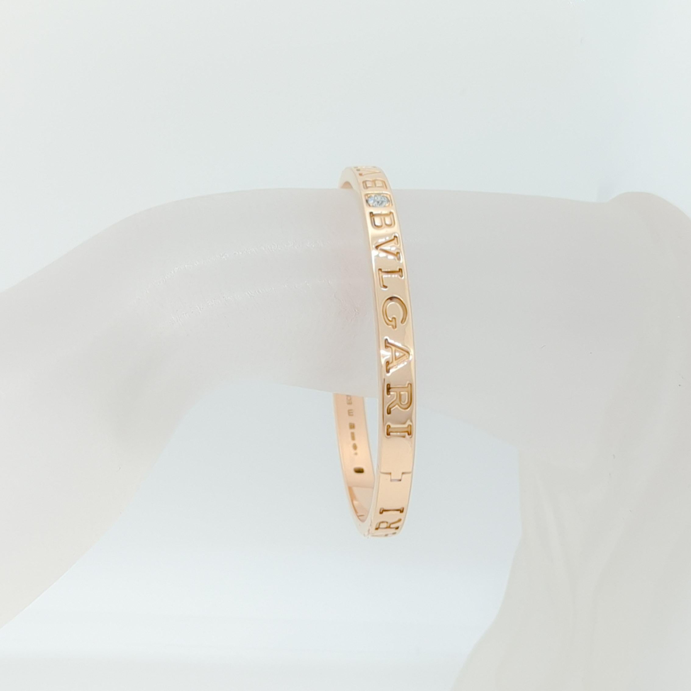 Stunning Bvlgari bangle with big white diamond rounds handmade in 18k rose gold.  A great addition to your arm stack or to wear on it's own.