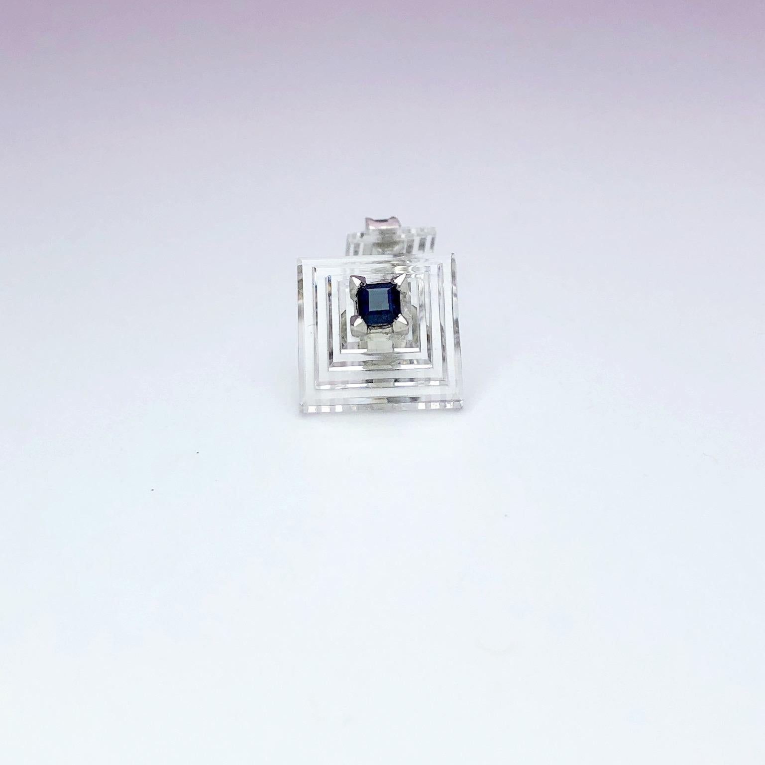 Carved crystal pyramid double ended cufflinks set with a square cut blue sapphire on either side . 
Signed Cartier
Platinum


