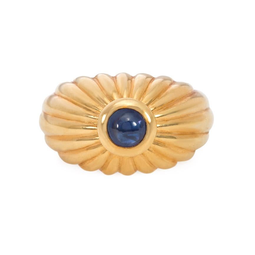 A gold and cabochon sapphire ring of fluted bombé design, in 18k.  Stamped and signed Cartier, numbered 50-B14667, dated 1991.  Sits approximately 5/16