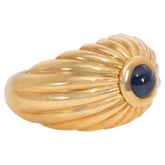 Estate Cartier Ribbed Gold Bombé Ring with Cabochon Sapphire Center