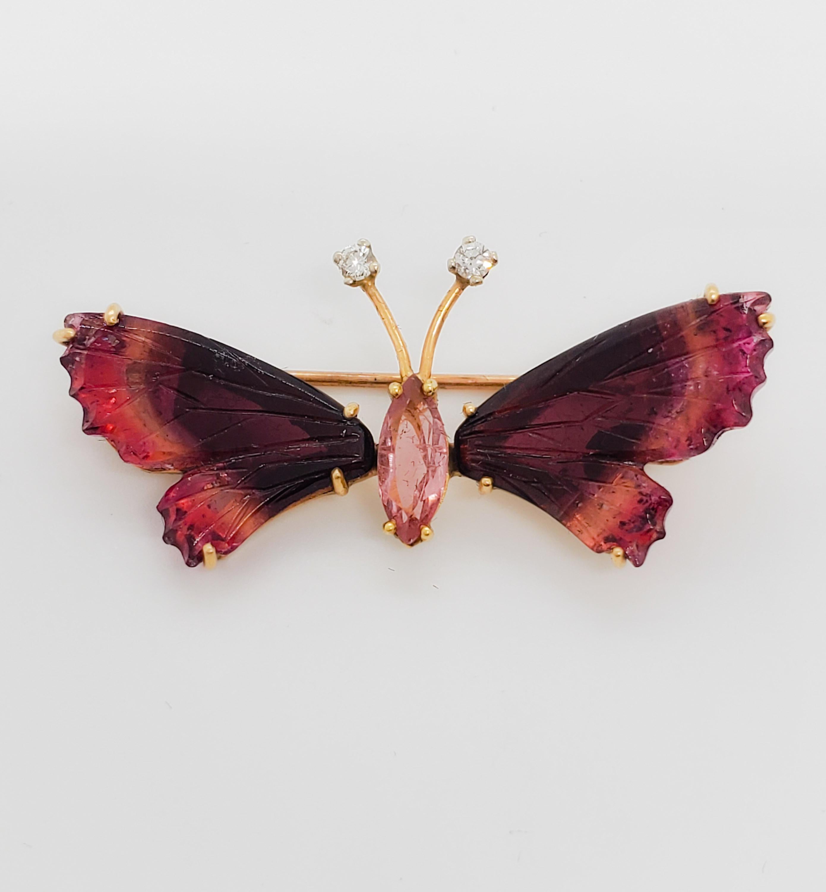 Beautiful brooch featuring 15 ct. of deep pink carved tourmaline as wings and center body of butterly.  0.05 ct. good quality white diamond rounds as antennae.  Handmade in 14k yellow gold.  Great attention to detail, dainty, and feminine.