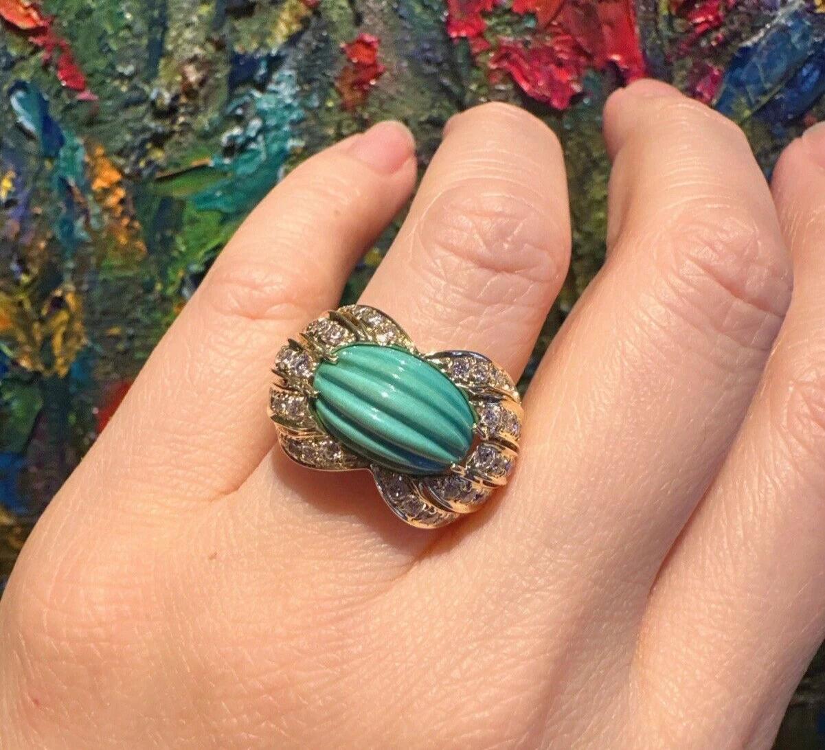 Estate Carved Turquoise & Diamond Cocktail Ring in 18k Yellow Gold

Diamond and Turquoise Ring features a Carved Oval Turquoise flanked by five rows of Round Brilliant Diamonds tapering down the side, all set in 18k Yellow Gold.

Total diamond