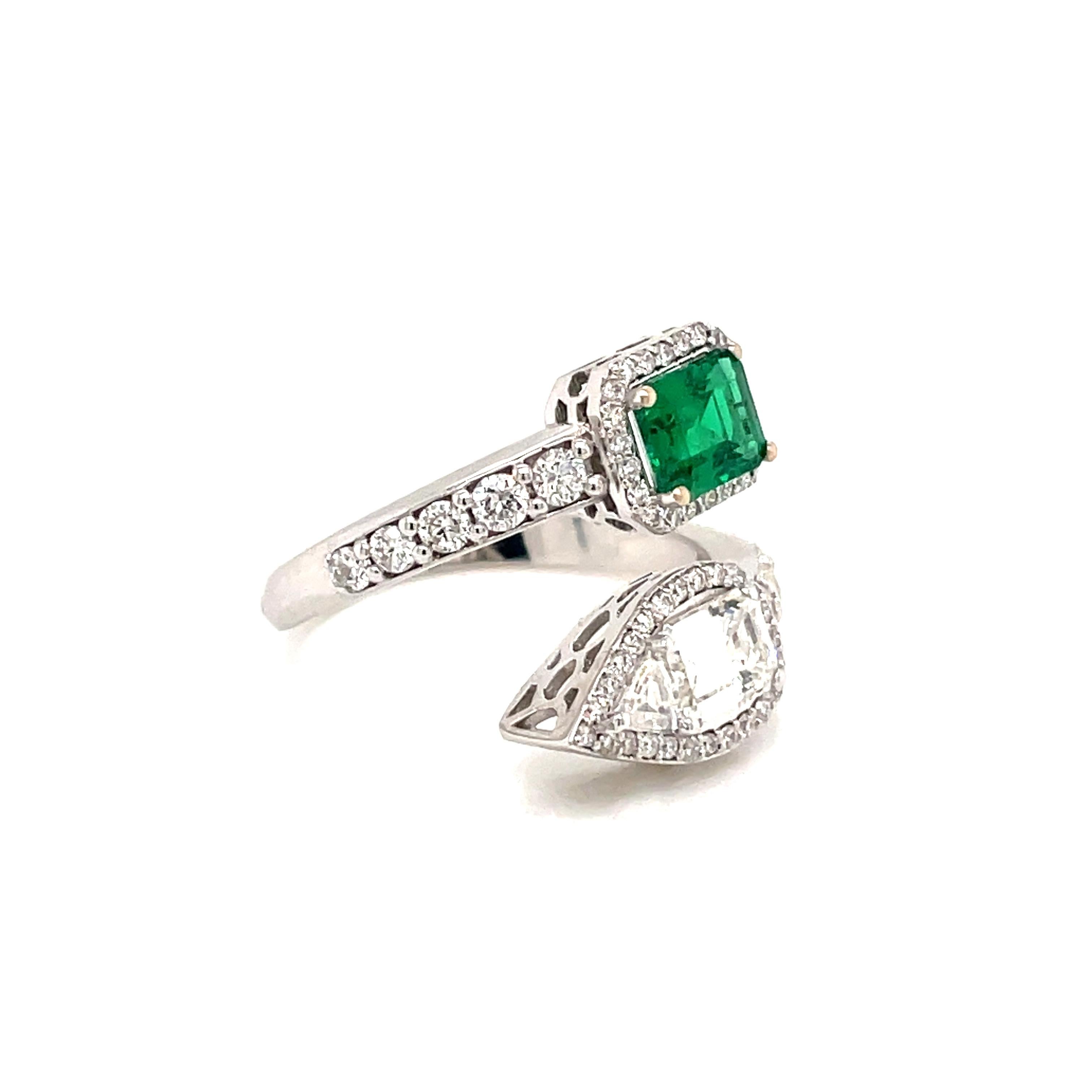 Beautiful Italian Emerald Diamond Estate Ring
An 18K white gold bypass ring, set with one vivid Natural Certified Colombian Emerald, approx. 1 ct, and a large sparkling Emerald cut diamond and a smaller trillion cut diamond. Weights are 0.70 cts for