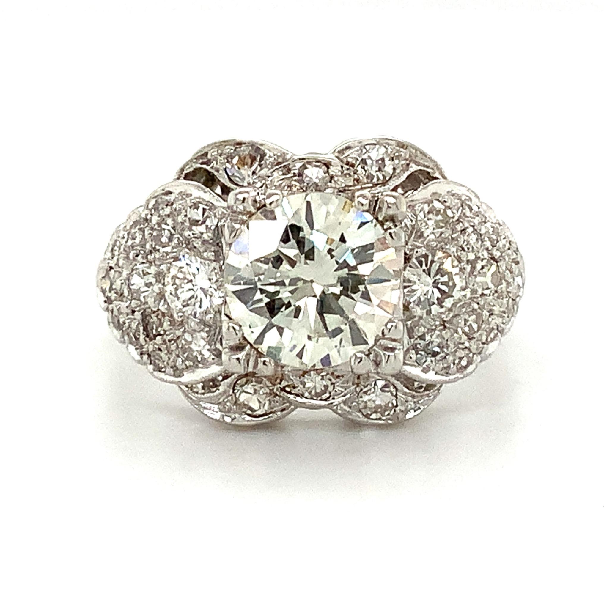 This exquisite Estate Diamond Ring is adorned with 33 Diamonds, with a total carat weight of 2.10cts. It includes 30 single cut Diamonds and two brilliant cut Diamonds, with a statement-making 1.35ct Center Diamond. This Center Diamond, of Modern