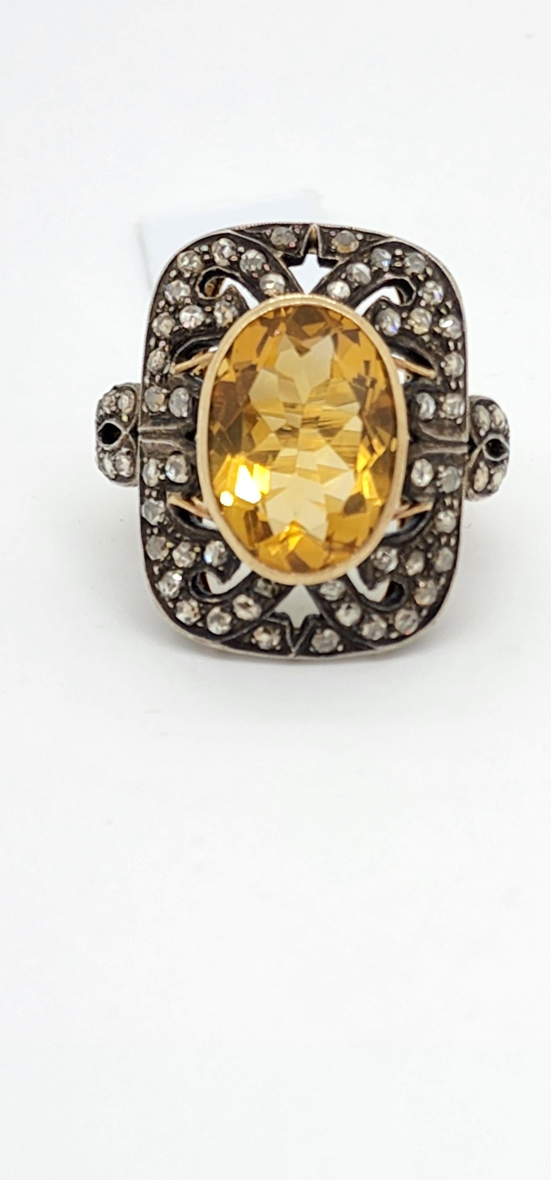 Gorgeous citrine oval with diamond rose cut rounds.  Handmade in 14k yellow gold and black rhodium.  Exact weights are unknown because the piece is estate.  Ring size 9.
