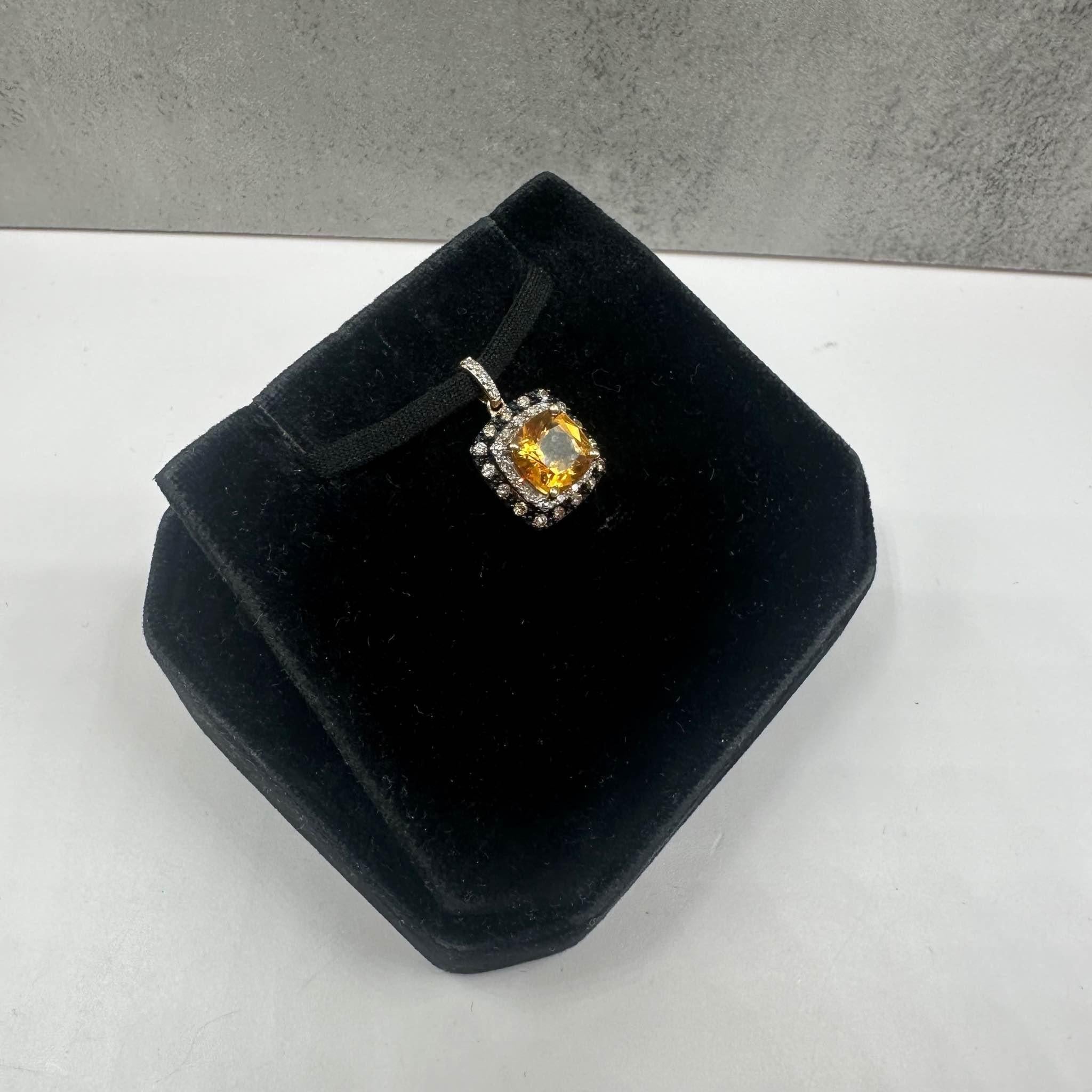 This elegant Estate Citrine and Diamond Pendant in 10kt yellow gold features a 7.1mm cushion-cut citrine, complemented by approximately 0.10ctw of natural IJ I1 round diamonds for added sparkle. The black rhodium plating around the prongs creates a