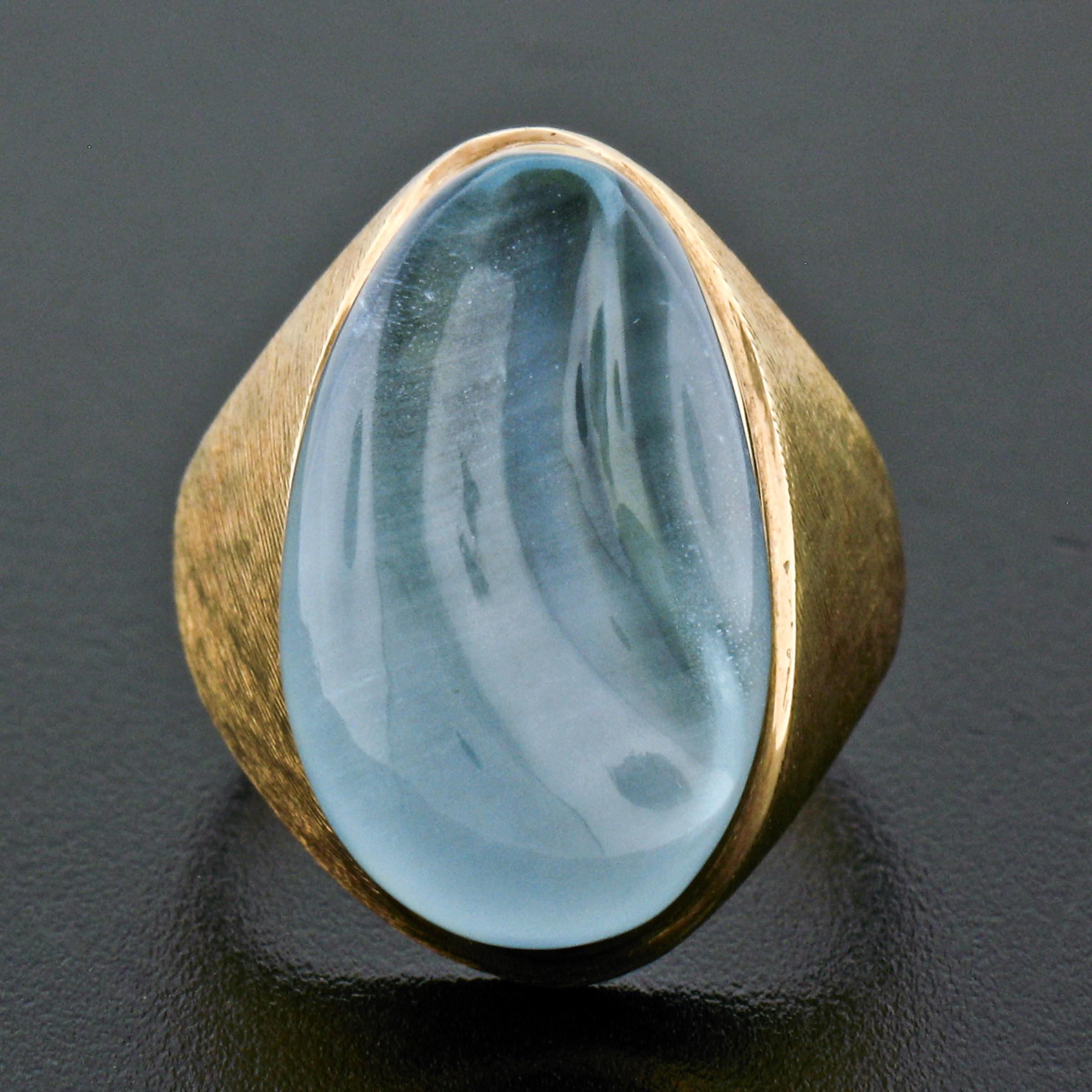 Here we have a rare, collectible modernist ring crafted in solid 18k yellow gold and designed by the famous Brazilian designer Burle Marx. The ring features a large, carved cabochon, natural aquamarine stone that displays the most lovely and