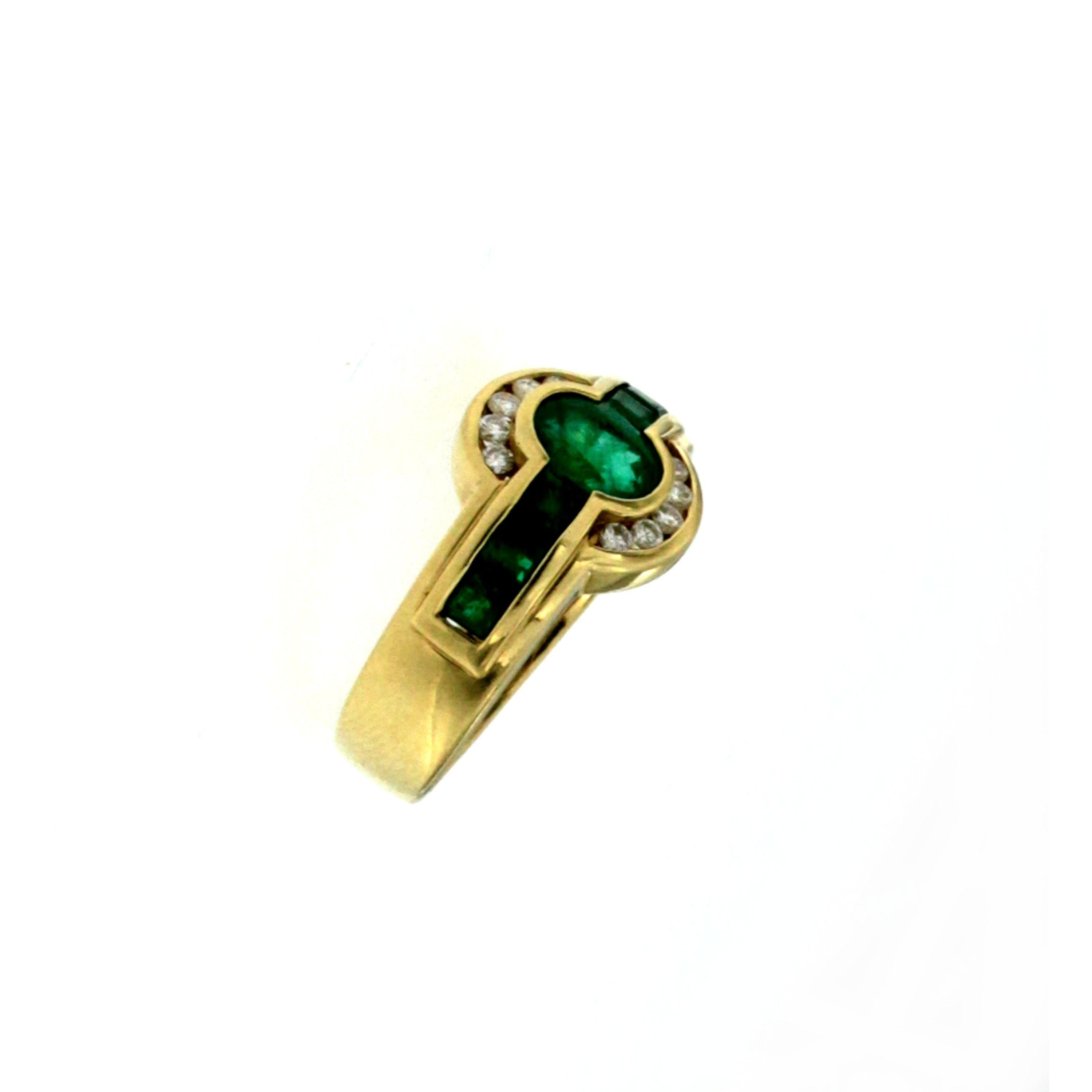 Stunning band ring, hand-crafted in 18k yellow gold, origin 1970 Italy
It is set with one large Vivid Colombian Oval Emerald in the center and at the two sides two rows of 6 custom cut smaller Emeralds, same quality, all surrounded by 10 round