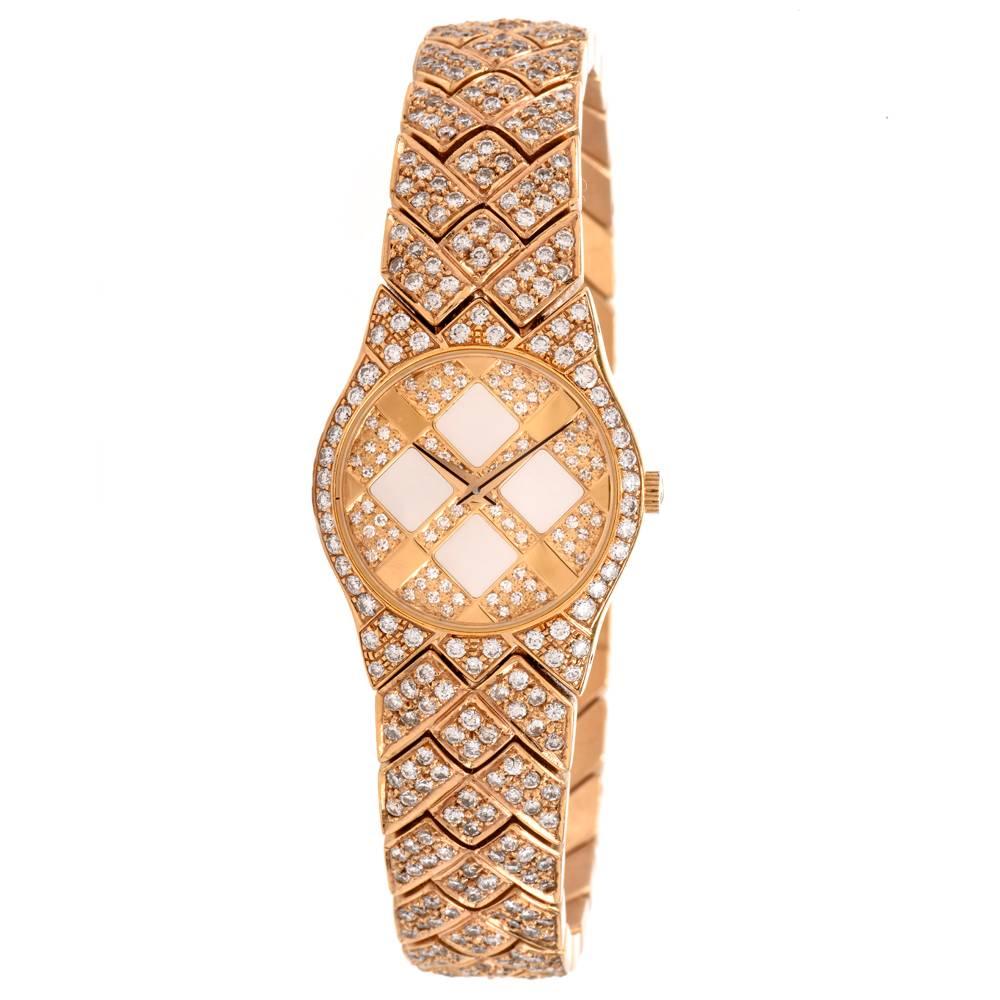 This estate Concord ladies Swiss-made wristwatch with an integrated diamond-swathed bracelet is crafted in 18 Karat yellow gold, weighs 103.4 grams and measures 7.5 inches long. The watch features a round case measuring 23 mm in diameter with water