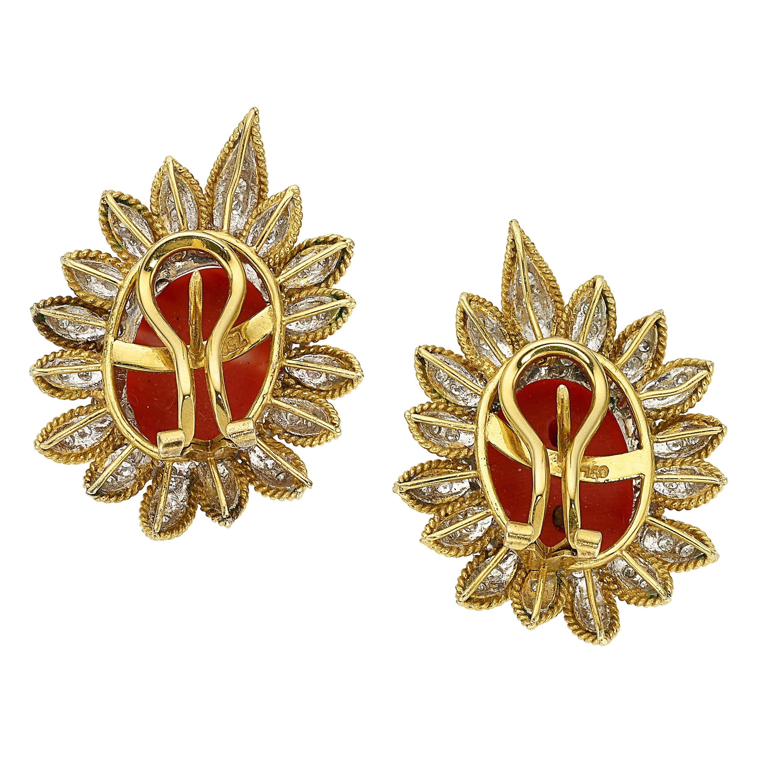 The earrings feature oval-shaped coral cabochons, enhanced by full-cut diamonds weighing a total of approximately 3.30 carats, set in 18k yellow and white gold having rhodium finished accents.

Earring Dimensions: 1 1/2 inches x 1 1/8 inches