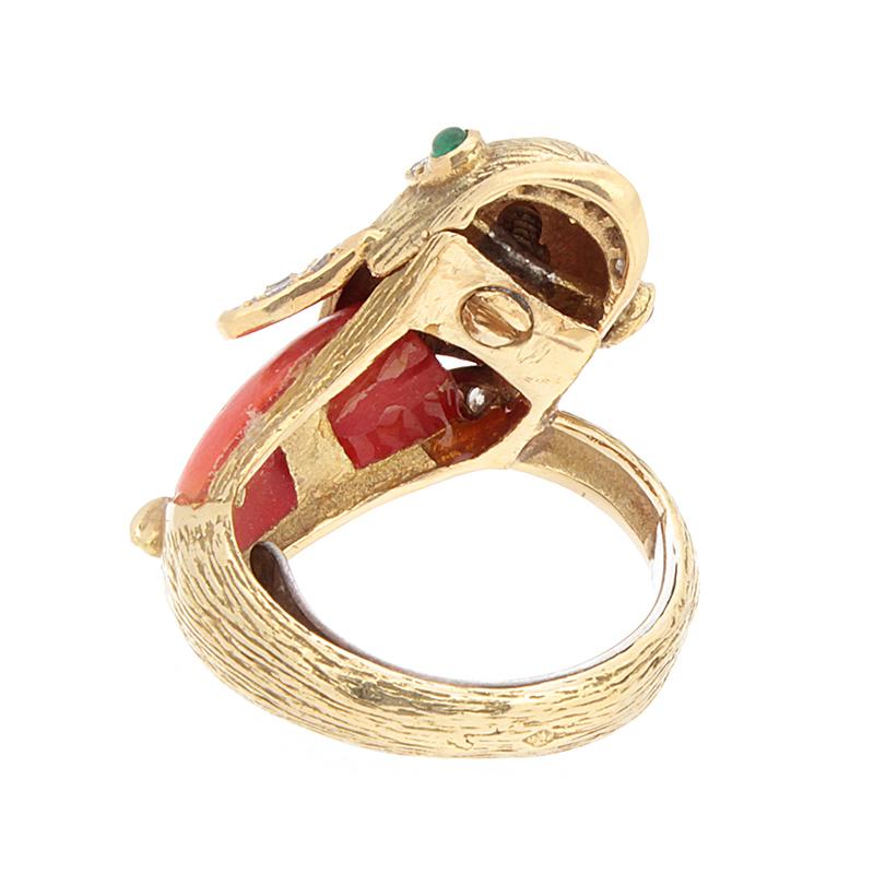 Yes, it’s a dolphin! This intricately designed ring was made with every attention to detail. A deep lustrous coral makes for the body of this dolphin, with cabochon emerald eyes and 0.20 carats of diamonds used along the fins and mouth. All set in