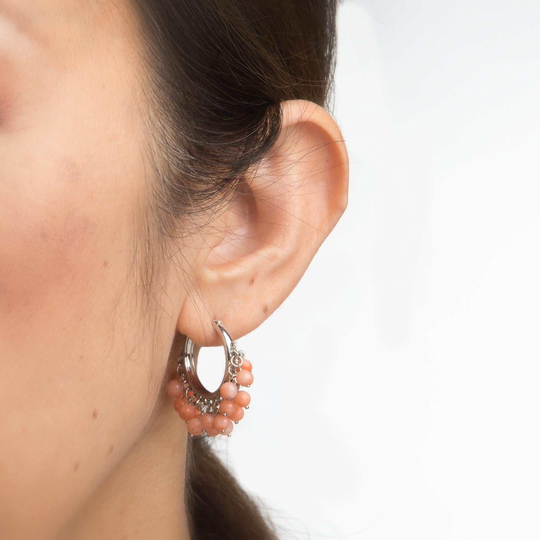 Elegant pair of estate coral hoop earrings, crafted in 18k white gold. 

Coral is attached to both bases of the hoop earrings measuring (average) 4mm. The coral is in excellent condition and free of cracks or chips. 

The stylish hoop earrings are