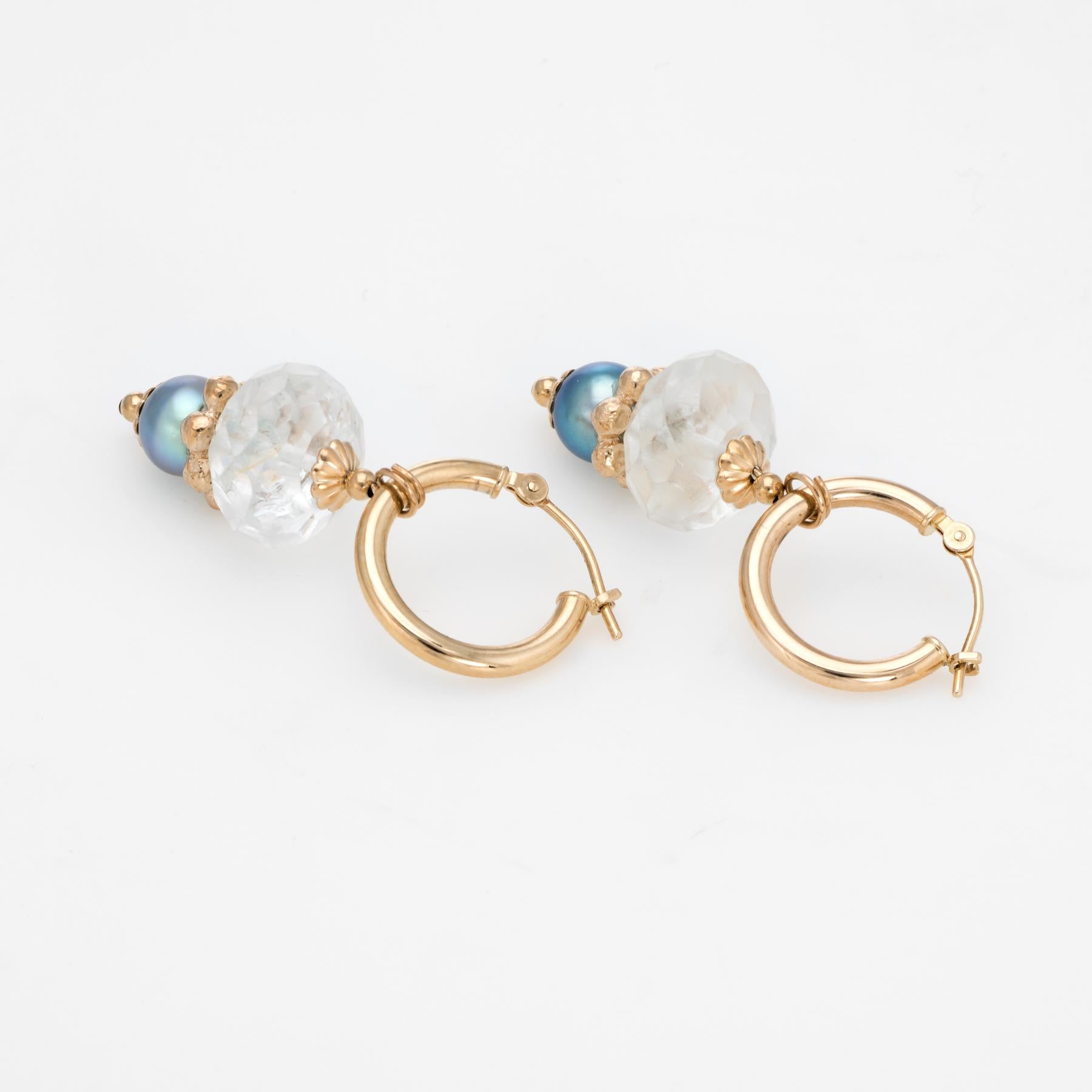 Elegant pair of estate cultured pearl & white quartz hoop earrings, crafted in 14k yellow gold. 

Cultured black pearls each measure 6.5mm. The faceted white quartz measures 12mm. 

The stones each securely set into the mounts. The drops are