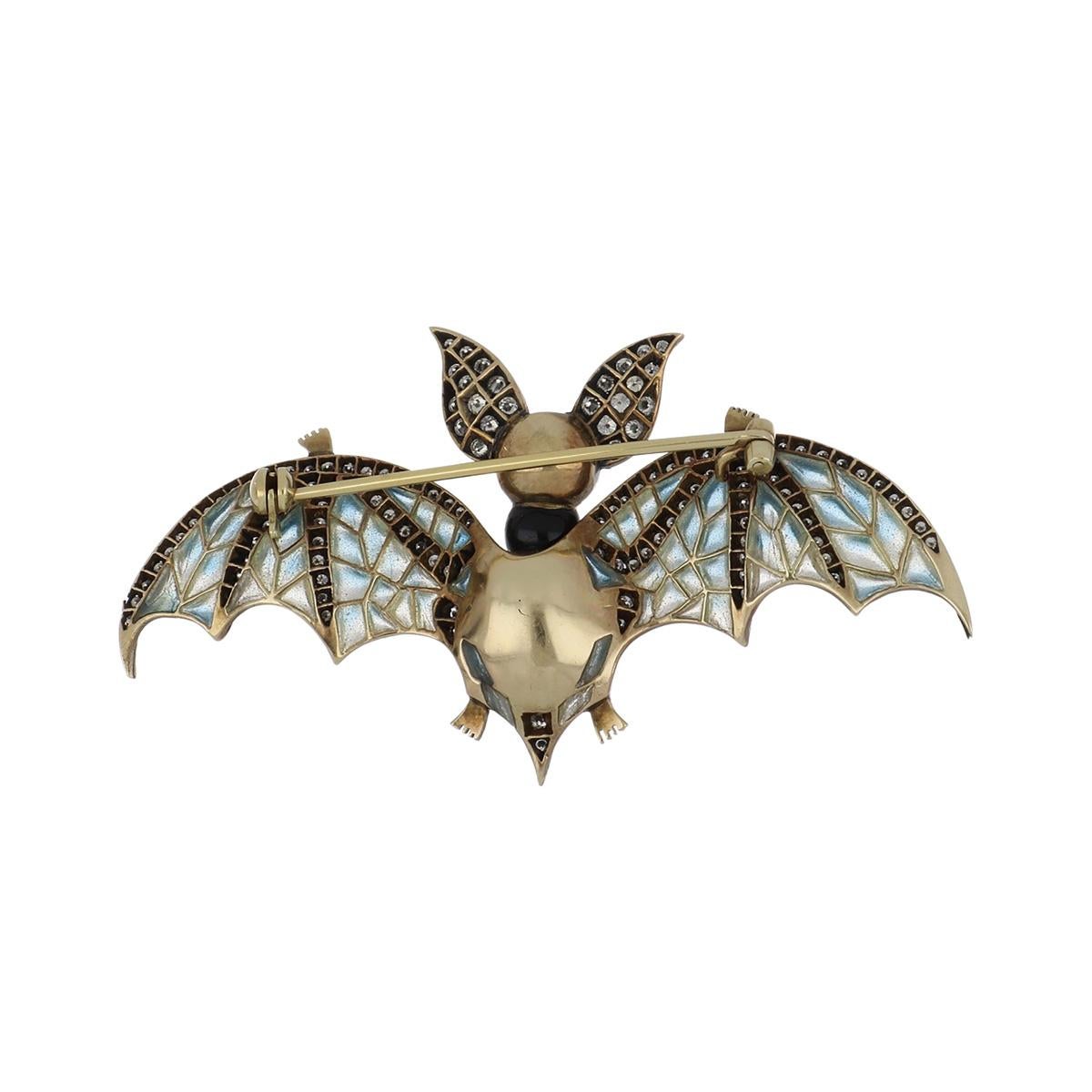 Estate 18K yellow gold cultured baroque Tahitian pearl and diamond bat pin. Created in Art Nouveau style, the bat has plique-à-jour enamel wings and a movable head, set with ruby eyes. The pin is set with round diamonds totaling 1.75 total carat