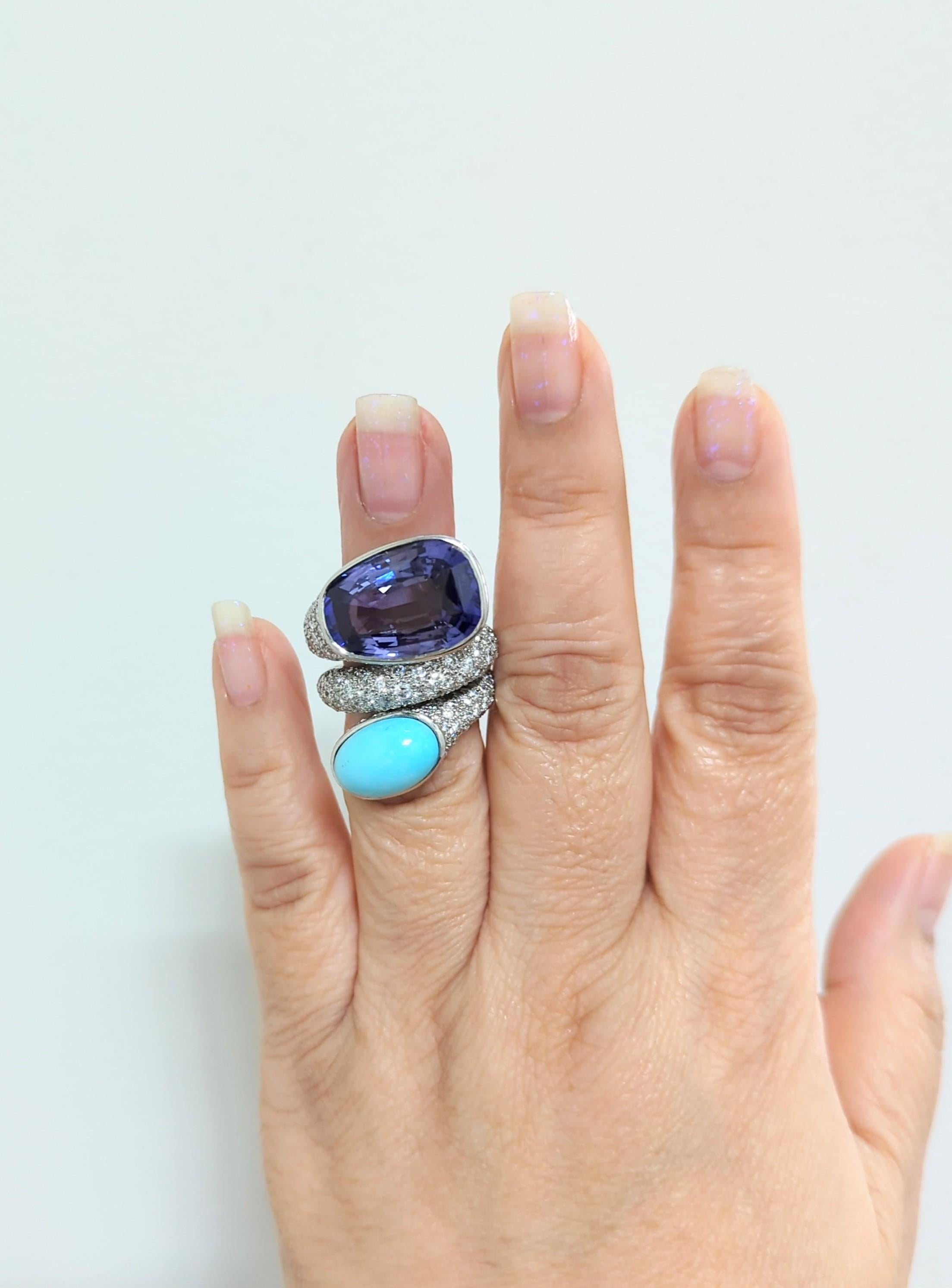 Gorgeous estate David Webb ring featuring a 18.65 ct. Ceylon blue sapphire with a 6.72 ct. turquoise cabochon.  Handmade in platinum.  Good quality white diamond rounds.  Ring size 6.5.