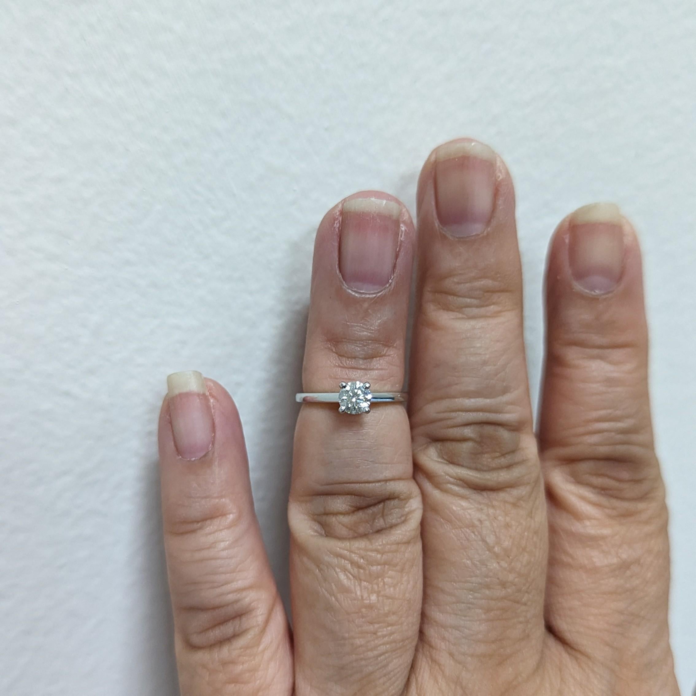 Beautiful 0.30 ct. De Beers white diamond round solitaire ring.  Handmade in platinum.  Ring size 4.