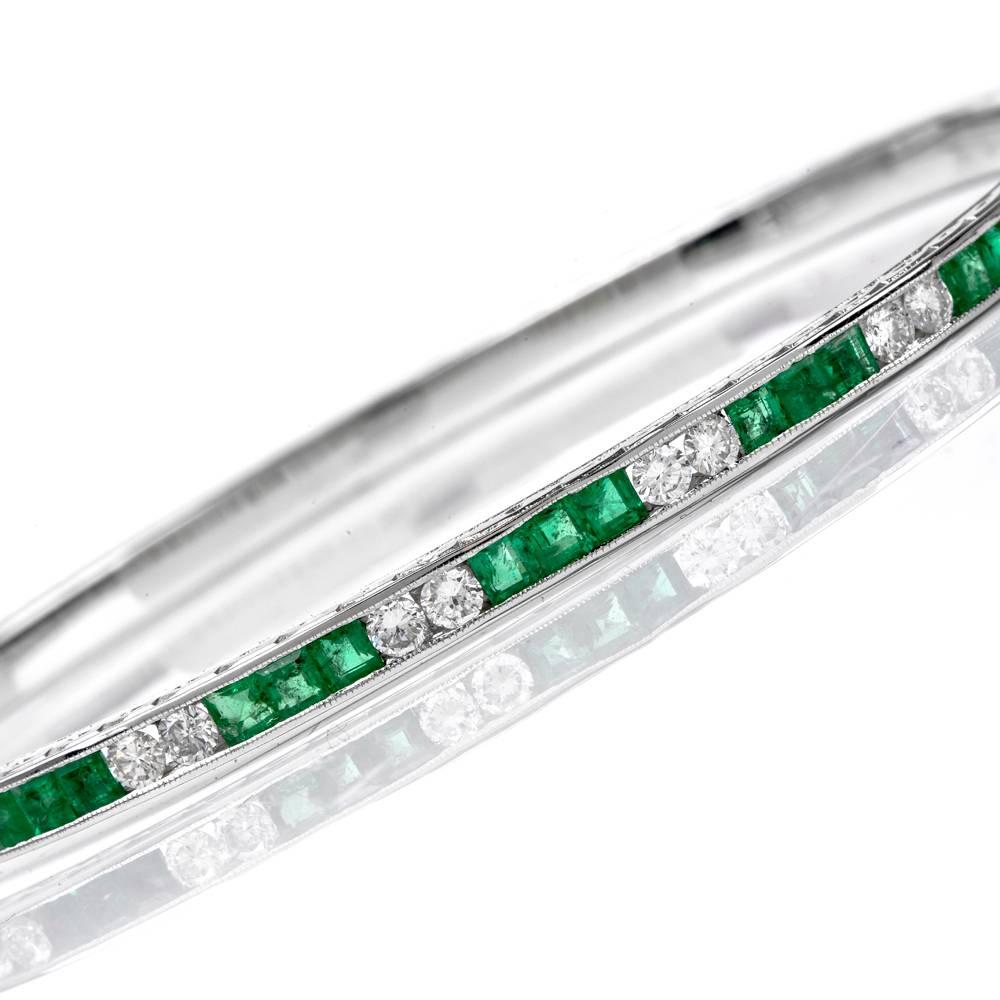 This Art Deco design bangle bracelet of feminine grace is crafted in solid 18K white gold, weighing 19.3 grams and measuring 7.5 inches around the wrist. The enchanting bracelet is enriched with 21 channel-set square-cut emeralds, total weight