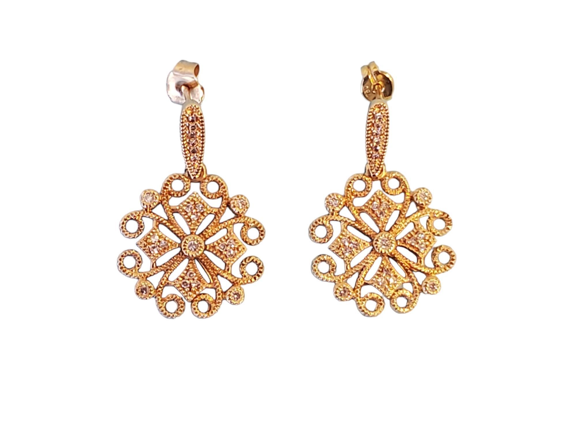 Listed are a pair of 18k yellow gold designer earrings with approximately .22tcw white clean diamonds. They are in excellent condition, unsure that they were even worn. They measure 30mm in length.