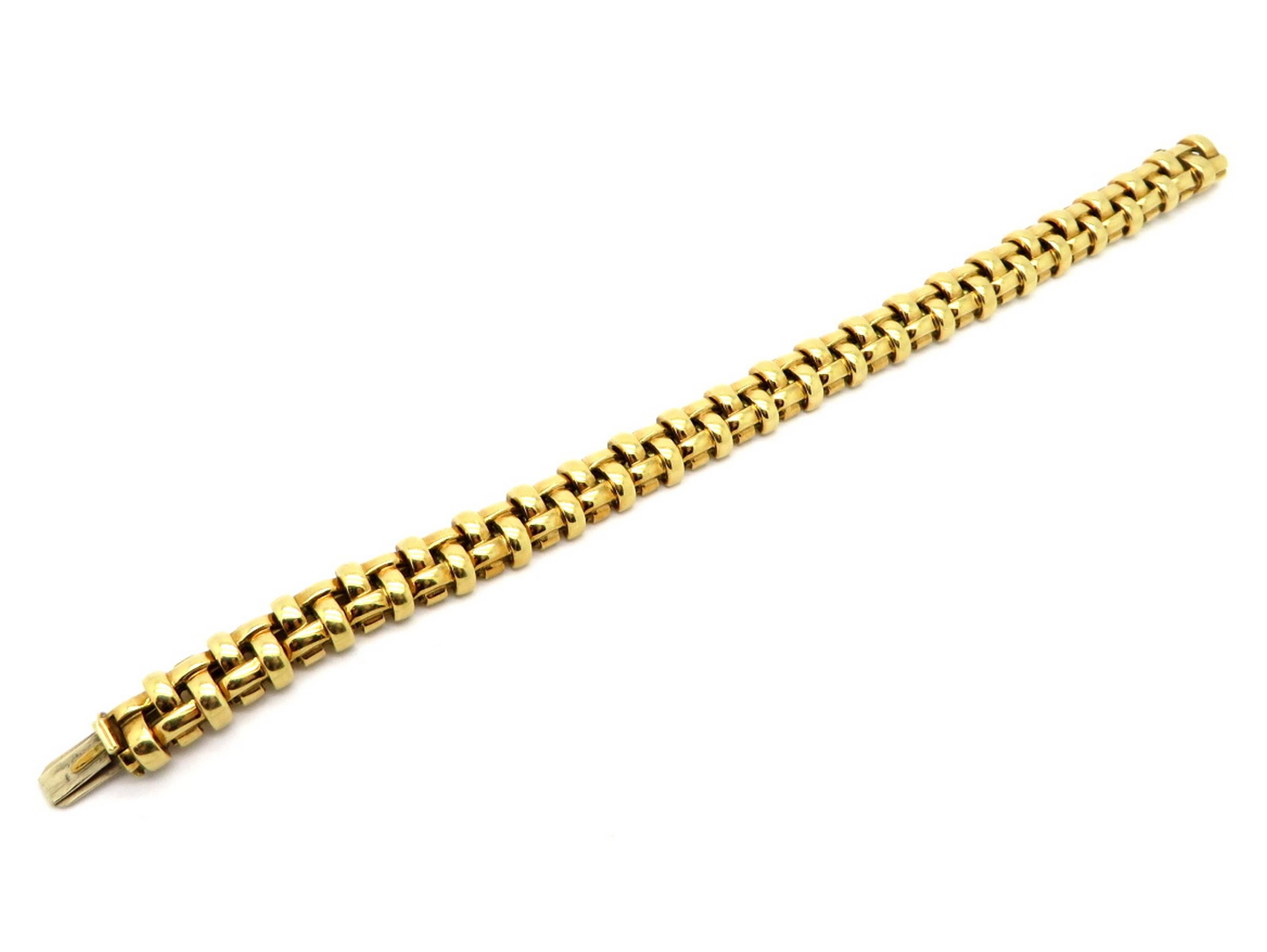 Estate designer Tiffany & Co. 18K yellow gold open basket weave Italian bracelet. Circa 2002. This genuine designer Tiffany & Co. bracelet features a basket weave motif. It measures 7” inches long and 10 mm wide. It is crafted out of 18K yellow gold