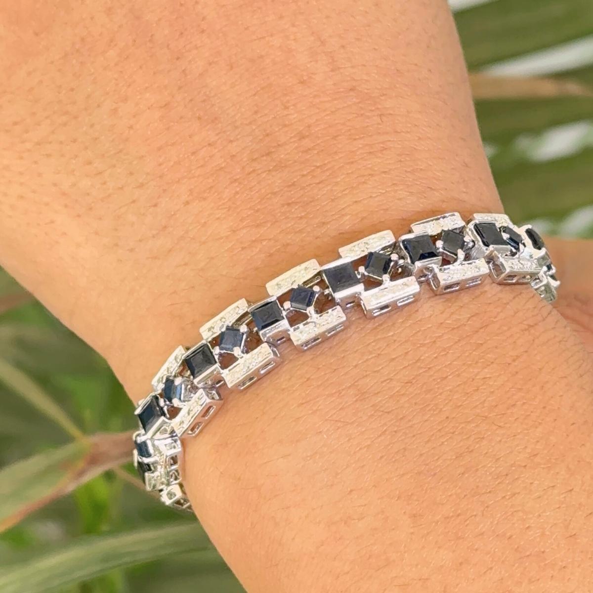 Estate Diamond and Blue Sapphire Tennis Bracelet in Sterling Silver showcases endlessly sparkling natural blue sapphire, weighing 10.60 carat and diamonds weighing 0.88 carats. It measures 7 inches long in length. 
Blue Sapphire improves mental