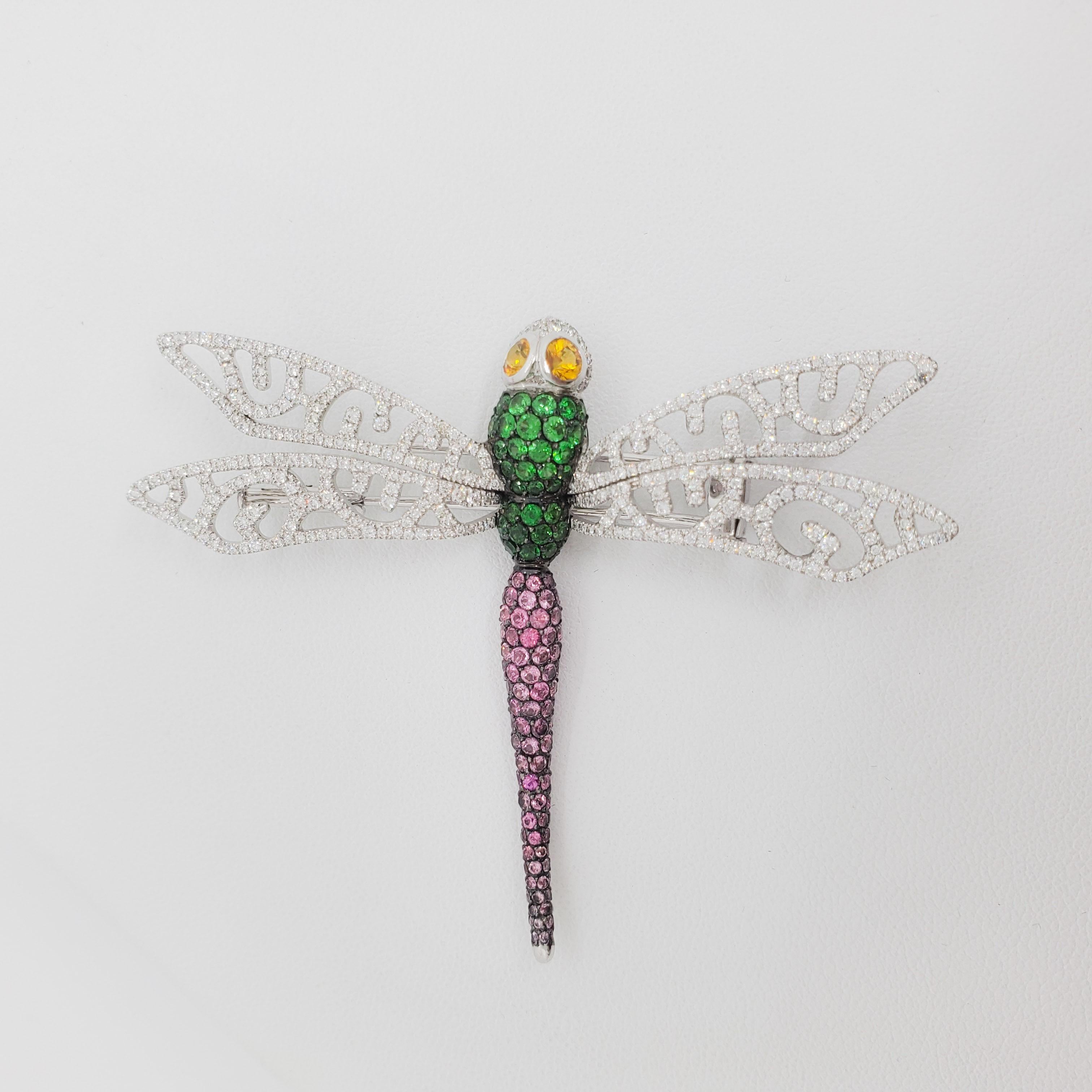 Beautiful dragonfly brooch with 1.29 ct. of good quality white diamonds, green and pink gemstones.  Handmade with careful thought and intricacy in 18k white gold.  