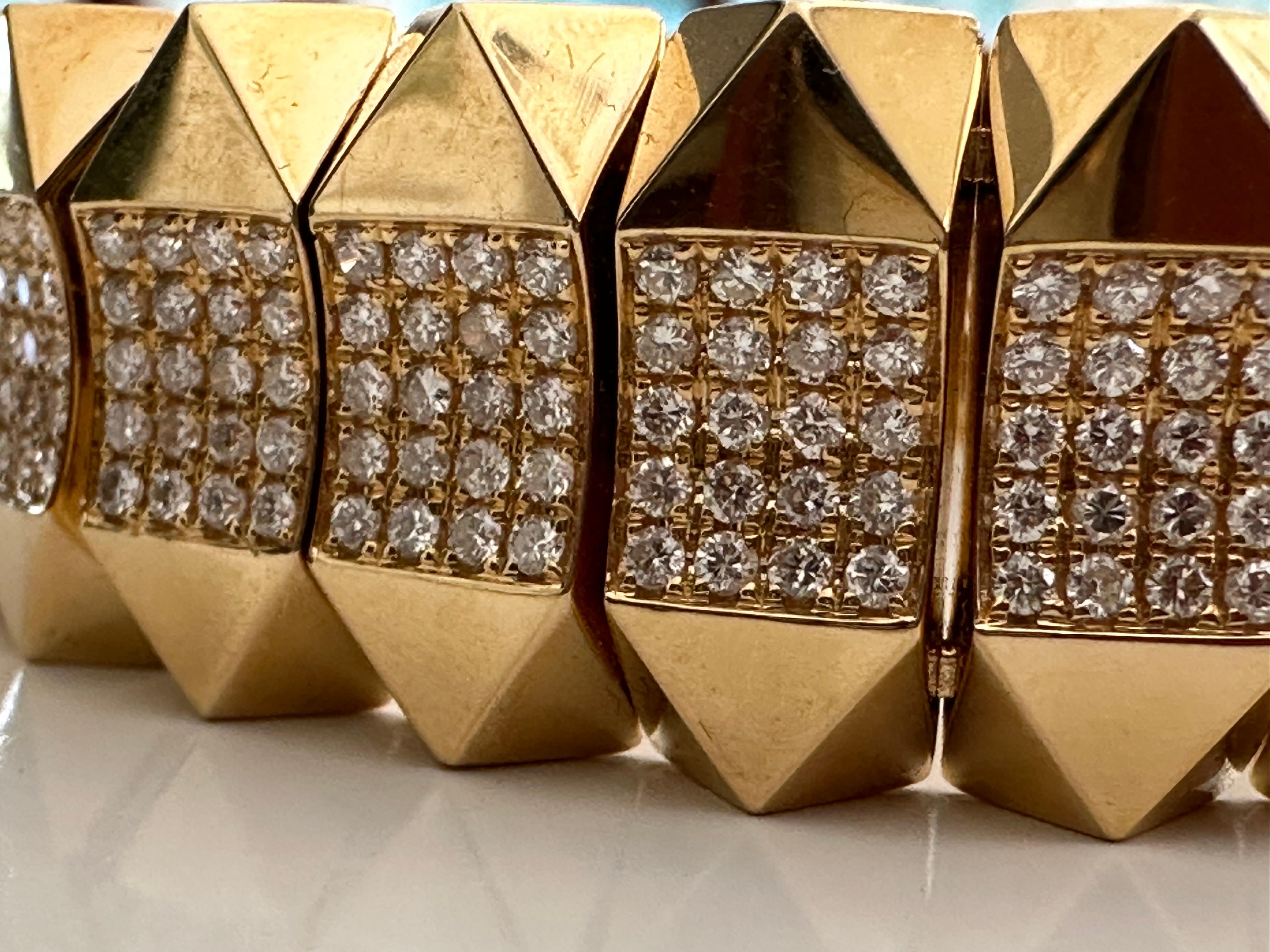 This bold, geometric Estate bracelet fashioned from 14kt yellow gold features approximately 6.00 carats of round-brilliant diamonds, G color, SI clarity arranged in the middle of stylized pyramid-shaped links. The bracelet measures 7 inches long and