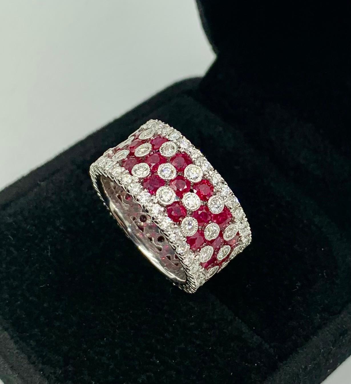 Excellent quality and fine design, the diamonds and rubies forming a X O pattern, perfectly suited for such a romantic ring. Eternity setting with the gemstones completely around the perimeter. The natural rubies invisibly set, 2.6 carat total