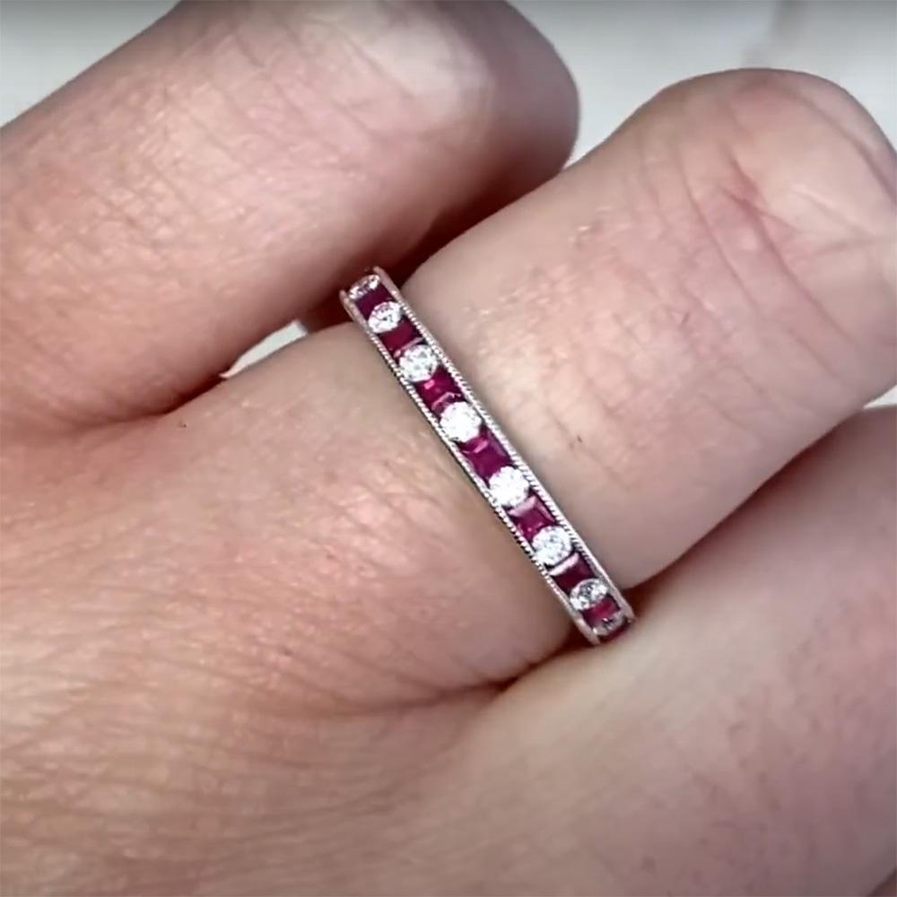 This exquisite half-eternity band is a testament to fine craftsmanship and timeless elegance. Meticulously handcrafted in 14k white gold, the band features a striking combination of dazzling diamonds and rich, natural rubies. The harmonious blend of