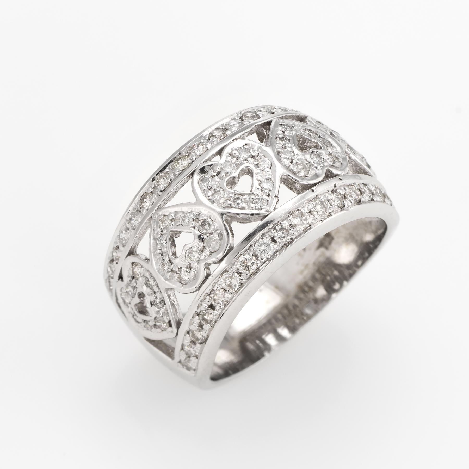 Finely detailed estate diamond heart ring, crafted in 14 karat white gold. 

Round brilliant cut diamonds total an estimated 0.76 carats (estimated at I color and I1 clarity). 

The 5 hearts are set in opposing form adding visual interest to the