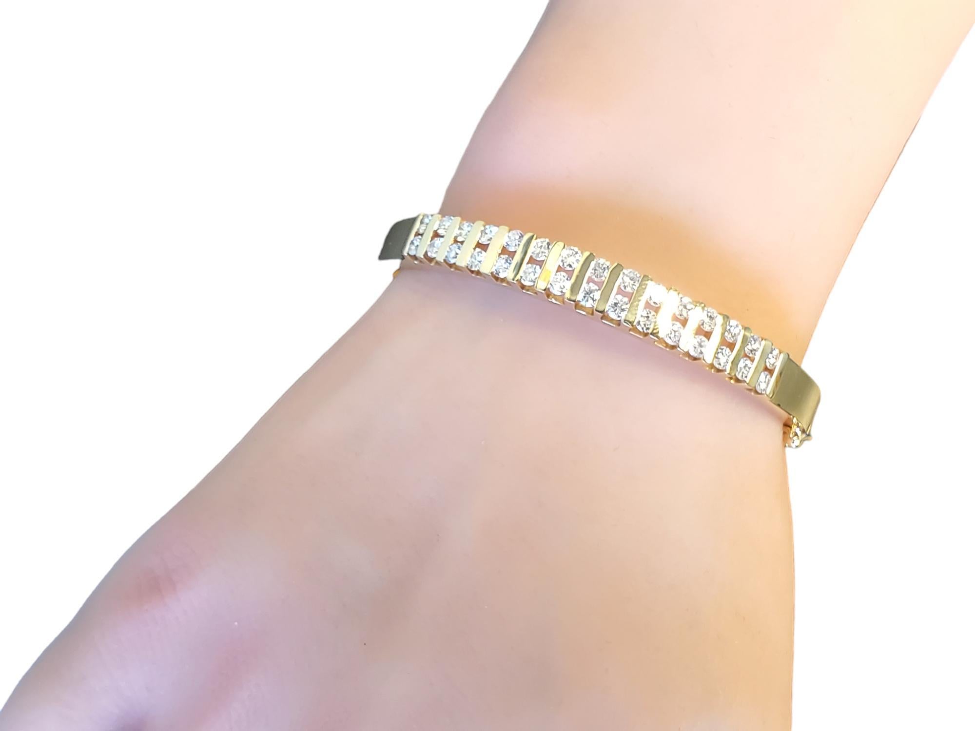 Listed is a 14k yellow gold estate diamond bangle. The bangle is in great condition, It features 30 round brilliant diamonds and is approximately 2.50tcw. The diamonds are I-J in color and VS-SI1, very nice stones. The clasp engages tightly and has