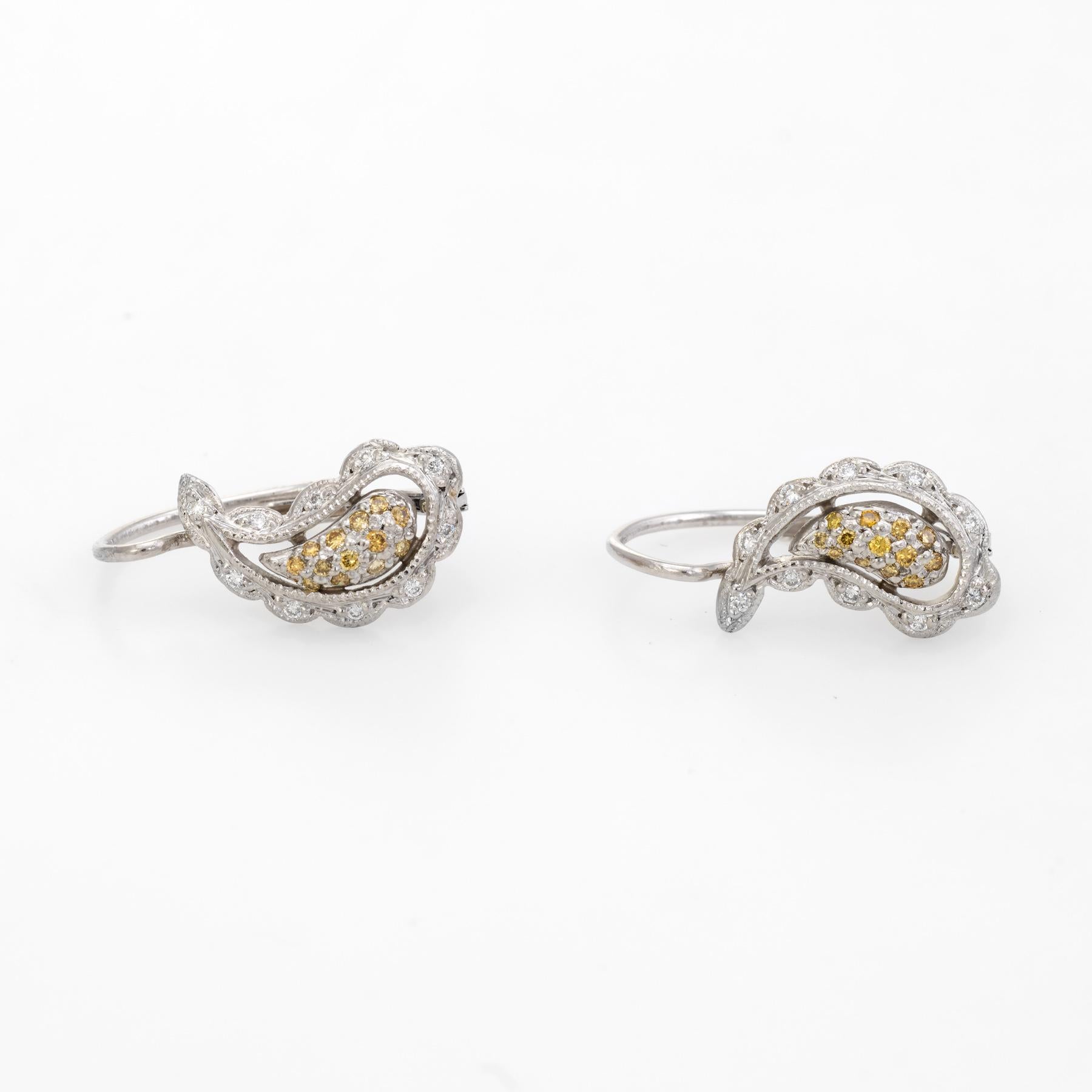 Dainty pair of estate diamond earrings, crafted in 14k yellow gold. 

26 yellow diamonds are set into the center of the earrings totaling an estimated 0.13 carats. The 20 white diamonds total an estimated 0.10 carats (estimated at H-I color and