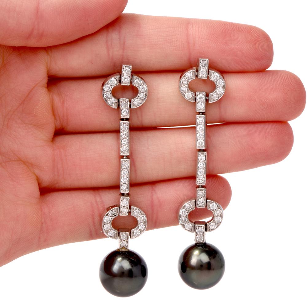 Theses alluring estate dangle drop earrings are crafted in solid 14K white gold, weigh 19.4 grams and measure 2.75” long. The earrings incorporate an artistic display of 64 round-cut diamonds of approx. 2.0 carats, IJ color, almost all VS clarity,