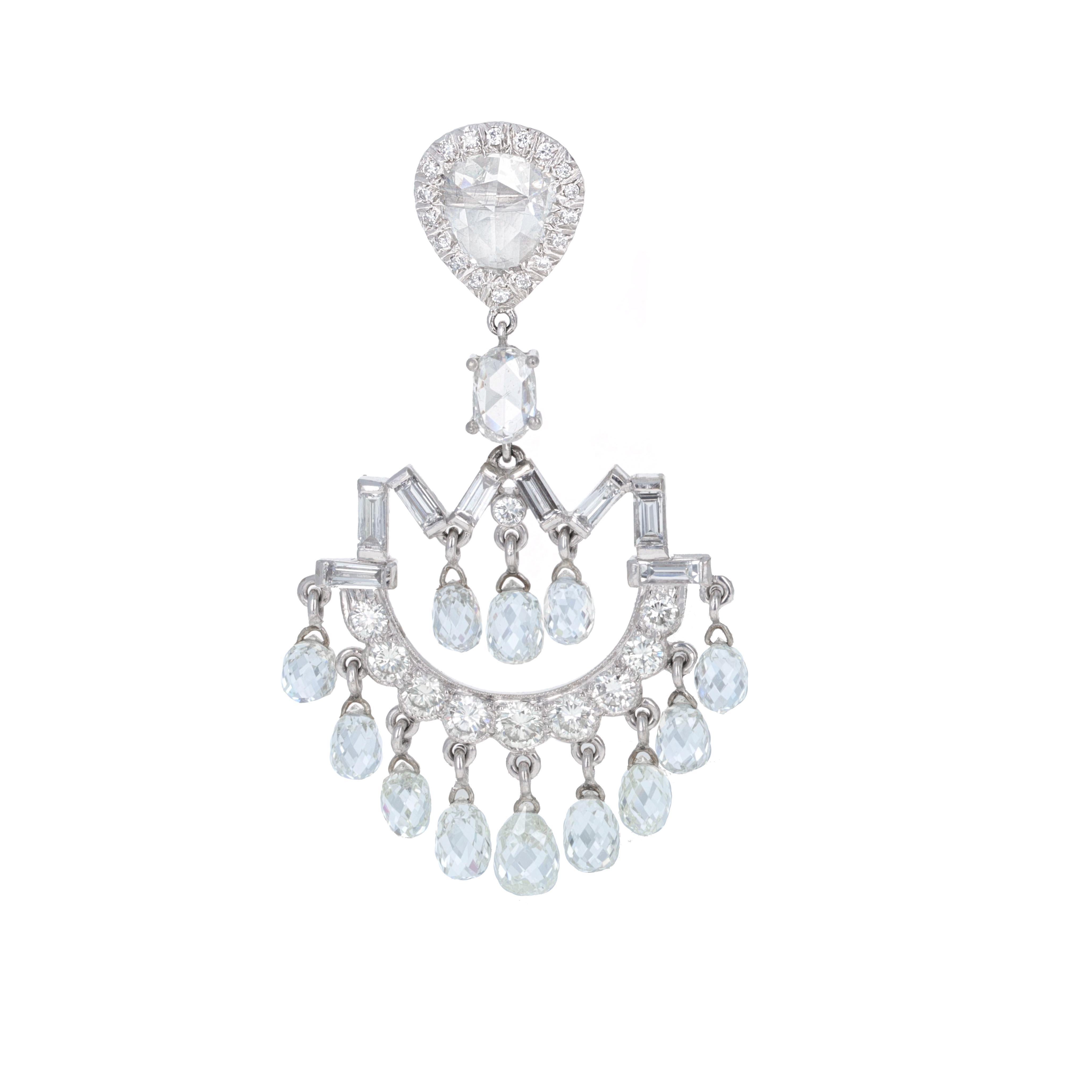 Beautifully designed estate diamond briolelle dangling earrings. The earrings are made in 18 karat white gold. The top of the earrings feature pear shaped rose cut diamonds. These chandelier earring are made to look Art Deco. There are 76 diamonds