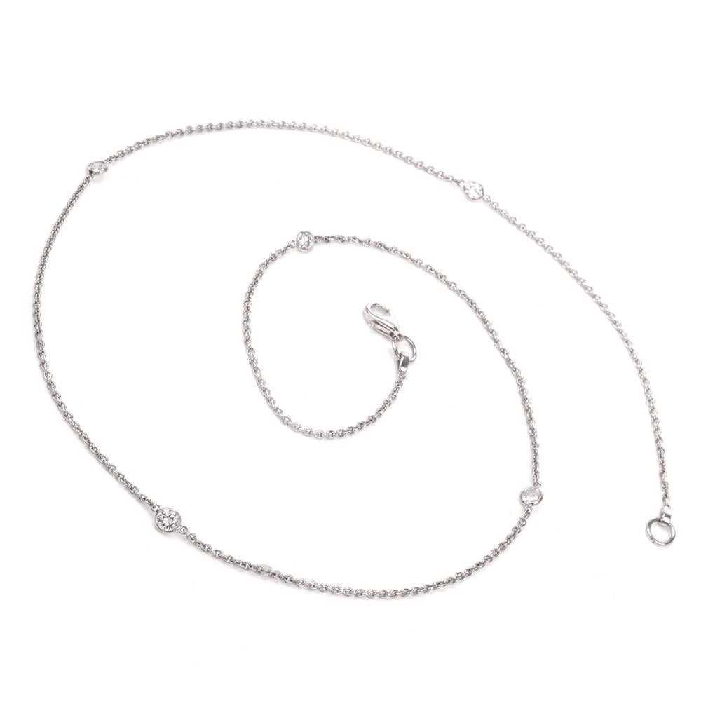 This estate diamond-by-the-yard necklace is crafted in 18-Karat white gold, weighs 4.5 grams and measures 19 inches long. Composed of delicate interlocking links, this chain necklace is adorned with 5 round-faceted diamonds cumulatively weighing