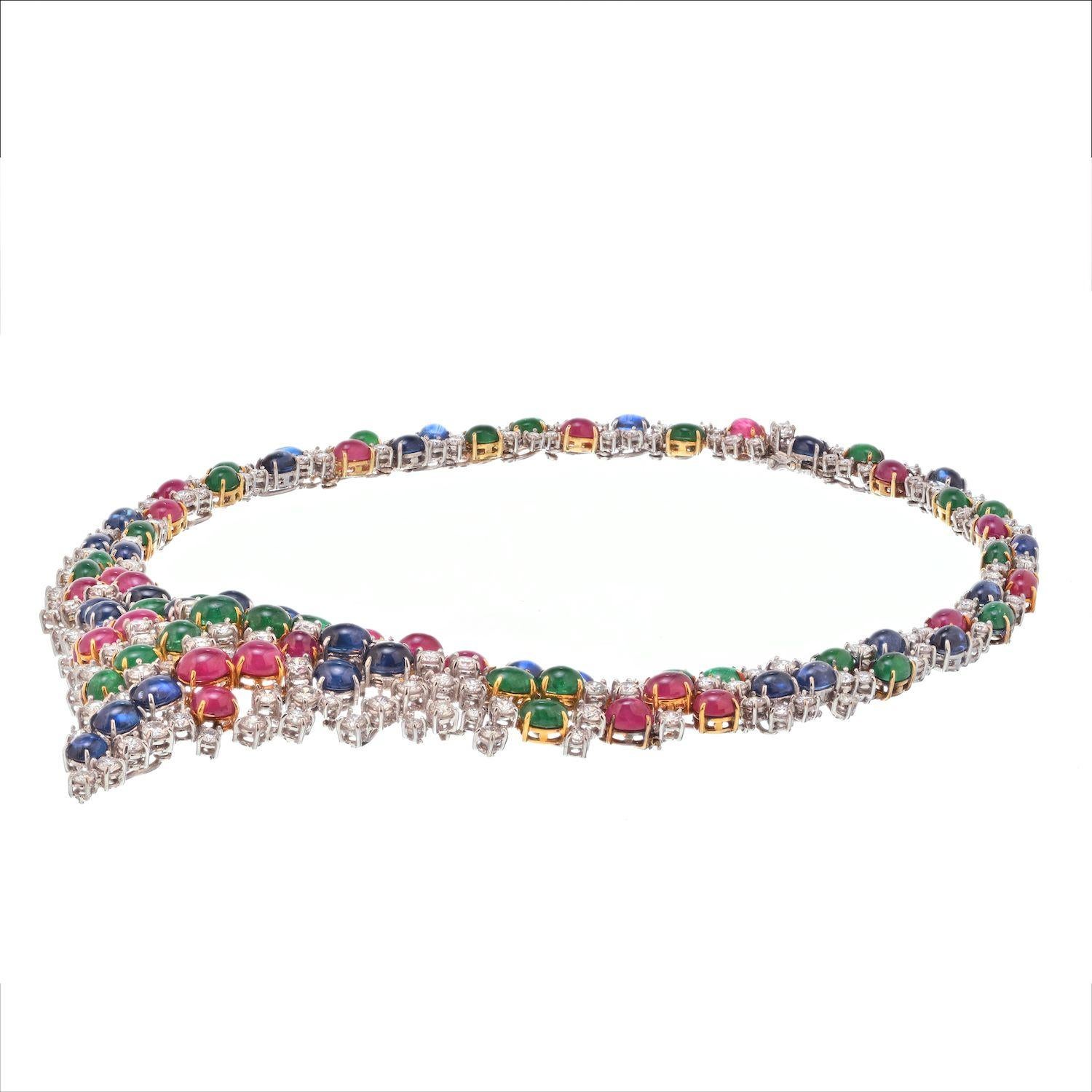 A spectacular necklace crafted in two tone gold, encrusted with 38 carats of gemstones: Rubies, Sapphires and Emeralds. Accented with round cut diamonds in between this is a fabolous necklace for someone who loves color and richness of the gems. 
A