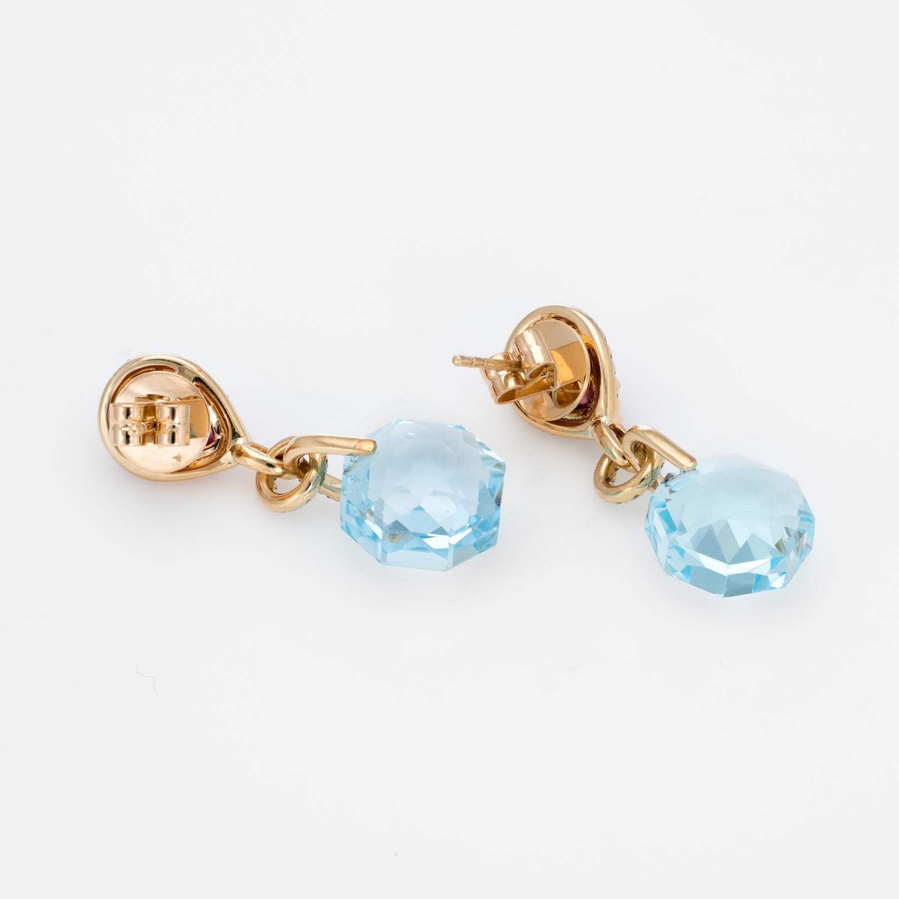 Elegant pair of estate diamond drop earrings, crafted in 18k yellow gold. 

Faceted hexagonal cut blue topaz measures 13mm (estimated at 12 carats each - 24 carats total estimated weight), accented with pear cut cabochon pink tourmalines measuring