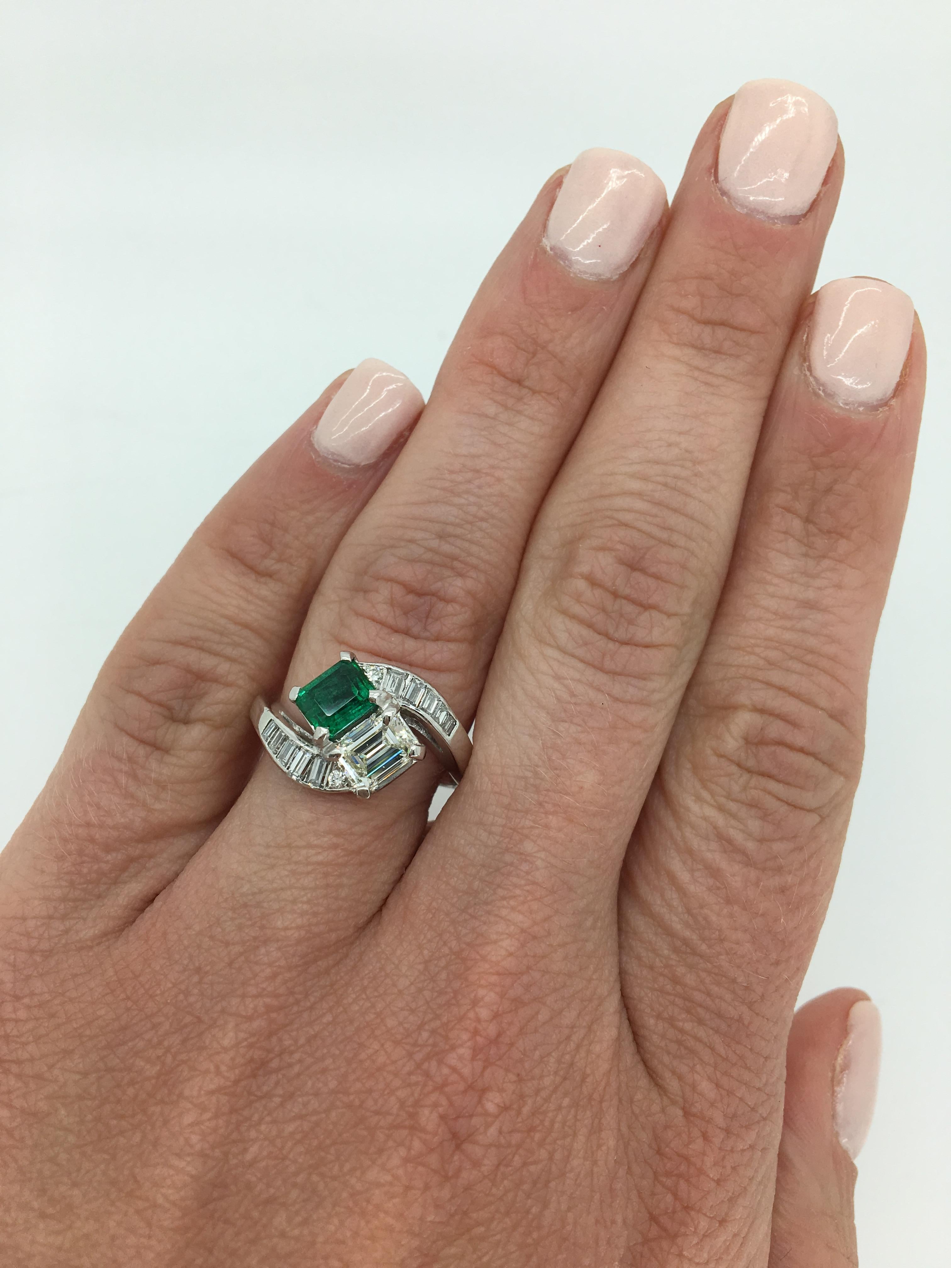 Diamond and Emerald bypass style ring crafted in platinum.

Gemstone: Diamond & Emerald
Gemstone Carat Weight: Approximately .60CT Emerald
Center Diamond Carat Weight: Approximately .70CT
Center Diamond Cut: Emerald Cut
Center Diamond Color: