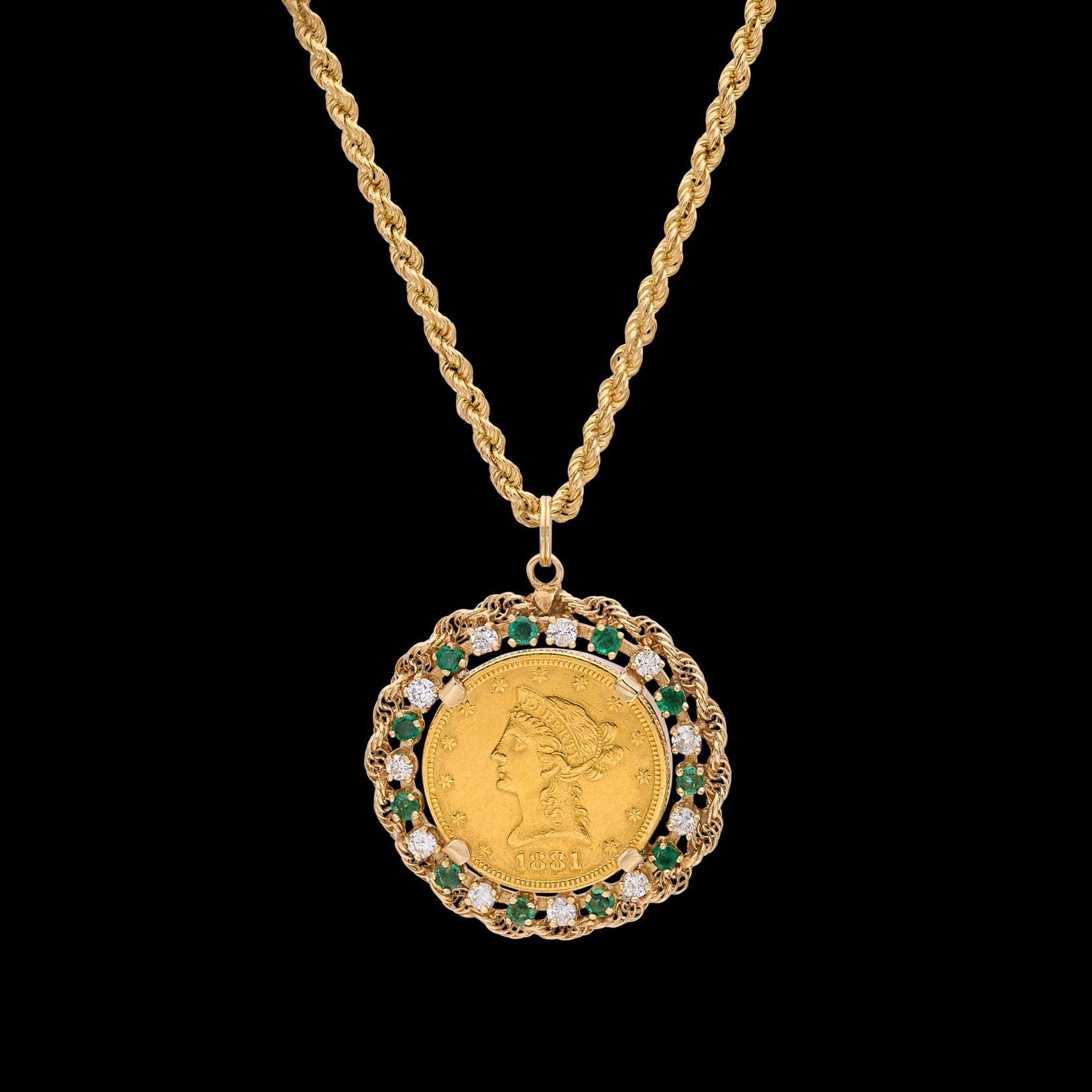 Circa 1970's, the 14k pendant features an 1881 US $10 Liberty Head gold coin, surrounded by 11 round-cut emeralds and 11 round brilliant-cut diamonds, weighing an estimated 1.20 carats, with a rope frame, and suspended from a 30-in. 14k gold rope