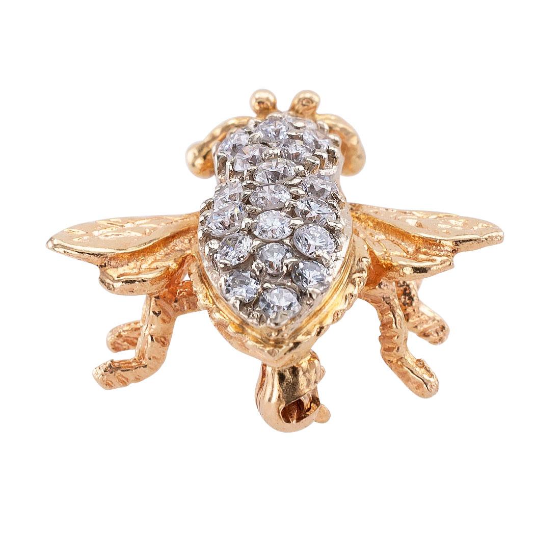 Estate diamond and yellow gold bee brooch circa 1980.

DETAILS:
DIAMONDS:  twenty-two round brilliant-cut diamonds totaling approximately 0.75 carat, approximately H – I color, I1 clarity.
METAL:  14-karat yellow gold.
WEIGHT:  4.6