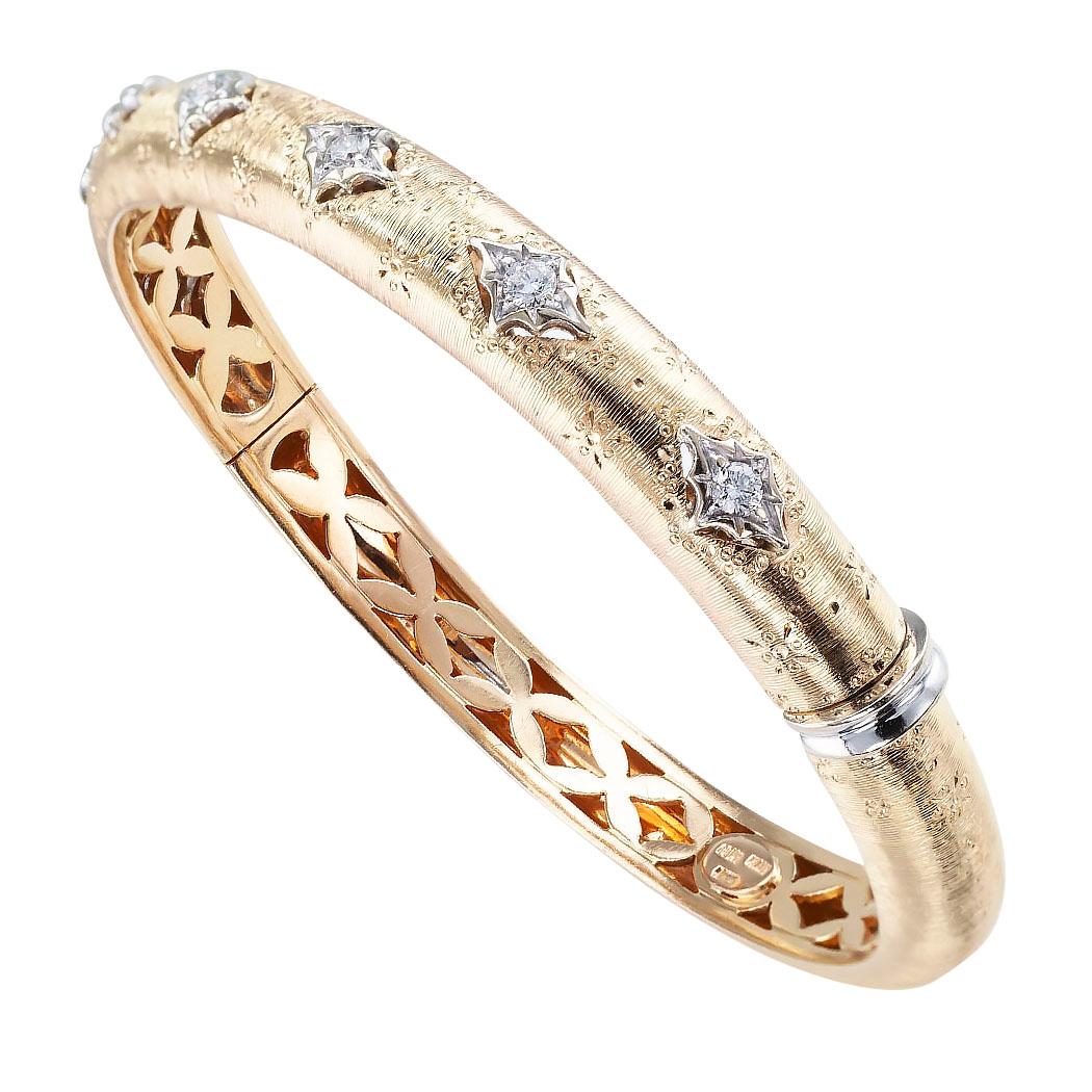 Estate diamond and gold Italian hinged bangle circa 1990.

DETAILS:
DIAMONDS:  seven round brilliant-cut diamonds totaling approximately 0.35 carat.
METAL:  18-karat yellow gold.
WEIGHT:  35.6 grams.
MEASUREMENTS:  approximately 7.5 mm wide,