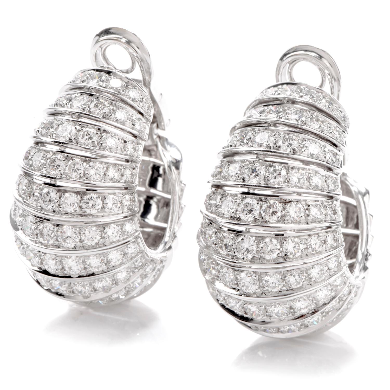 These earrings were created with an unbridled imagination and

inspired by a shell  motif. Exclusively hand Crafted in 18K white gold, 

these hoop earrings measure appx. 19.23mm wide x 30mm long.  

Rows of vibrant white diamonds cascade down

the