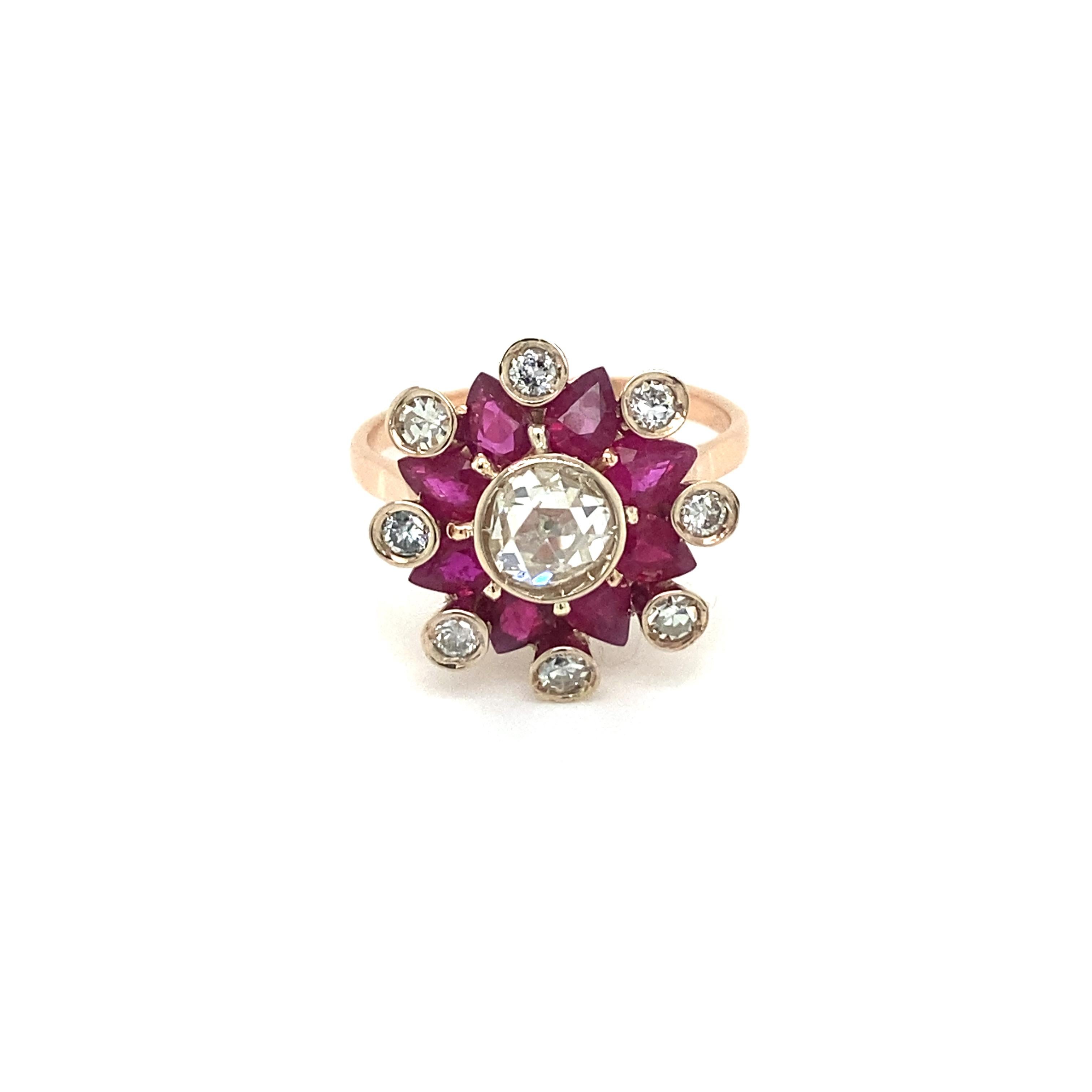 Beautiful 18k rose Gold Cluster Ring centered with a Sparkling Old mine cut Diamond weighing 0,90 carat, graded I color with Vs2 clarity. It is set with a fine Natural Unheated Rubies and diamonds halo,  weighing total 1,50 carats. 
Handmade in