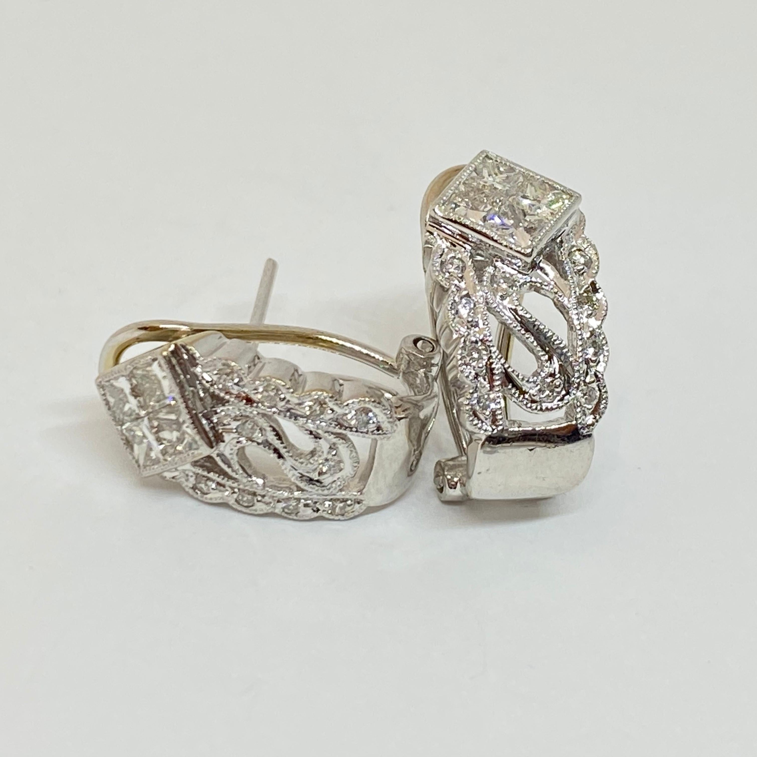 Estate diamond earrings designed in 14 karat white gold. Square princess and round brilliant cut diamonds are set in cutout filigree wide huggie earrings. French omega clip post earrings. The earrings measure 9mm x 16mm. The diamonds weigh 1.00