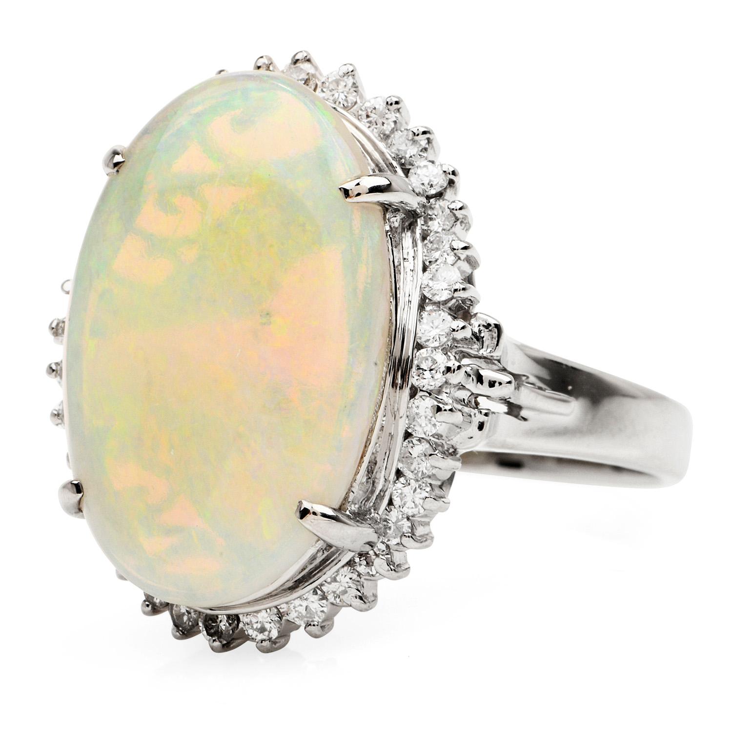 Multicolor genuine Opal & Diamond ring, with open style designs,

Crafted in solid Platinum, the center is adorned by a White Opal, cabochon oval cut & prong set weighing approximately 6.69 carats. 

Complimenting the sides, there are (10)