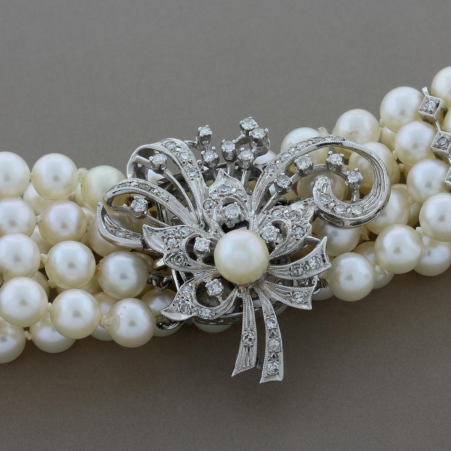 A precious bracelet featuring four strands of lovely delicate pearls with round cut diamond spacers. The box clasp and safety latch are hidden under the diamond studded flower made of 14K white gold.

Bracelet Length: 7 inches