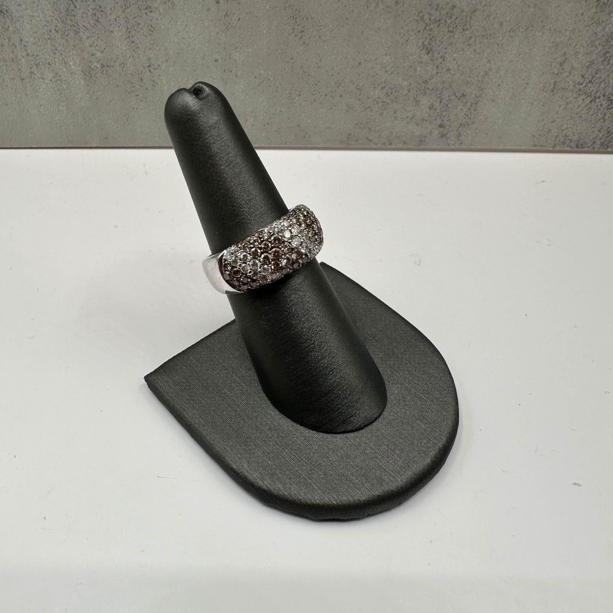 This stunning Estate Diamond Ring in 14kt white gold features approximately 1.10ctw of natural chocolate and HI SI2-I1 round diamonds, offering a unique contrast of colors and sparkle. Sized at 7, it fits most average finger sizes comfortably.