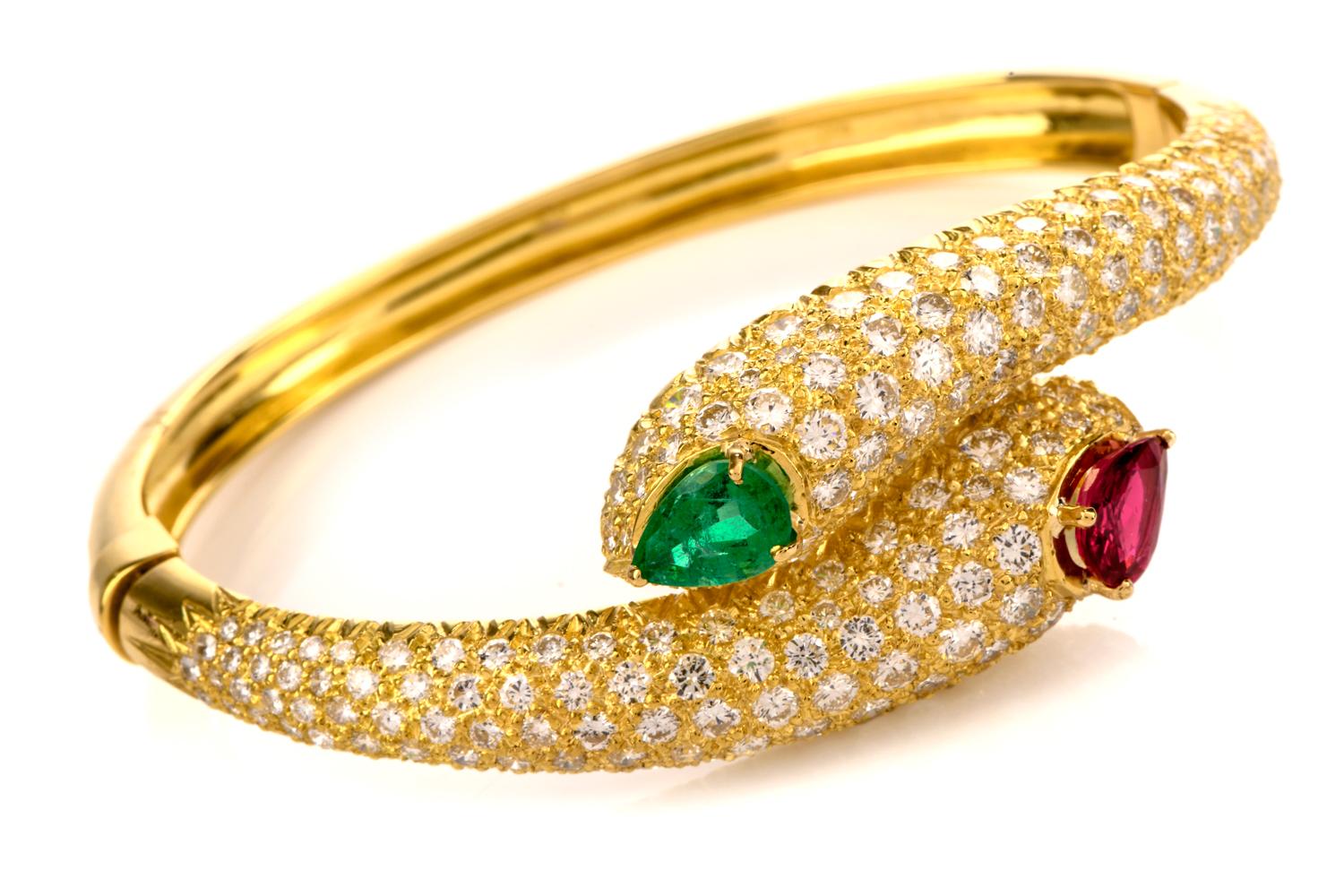 This breathtaking estate Diamond, Ruby and Emerald bracelet is inspired by 

a serpent bypass design and crafted in approximately 34.7 grams of

18k gold.  It contains a hidden locking clasp for continuity.

Some 180 Round Diamonds weigh