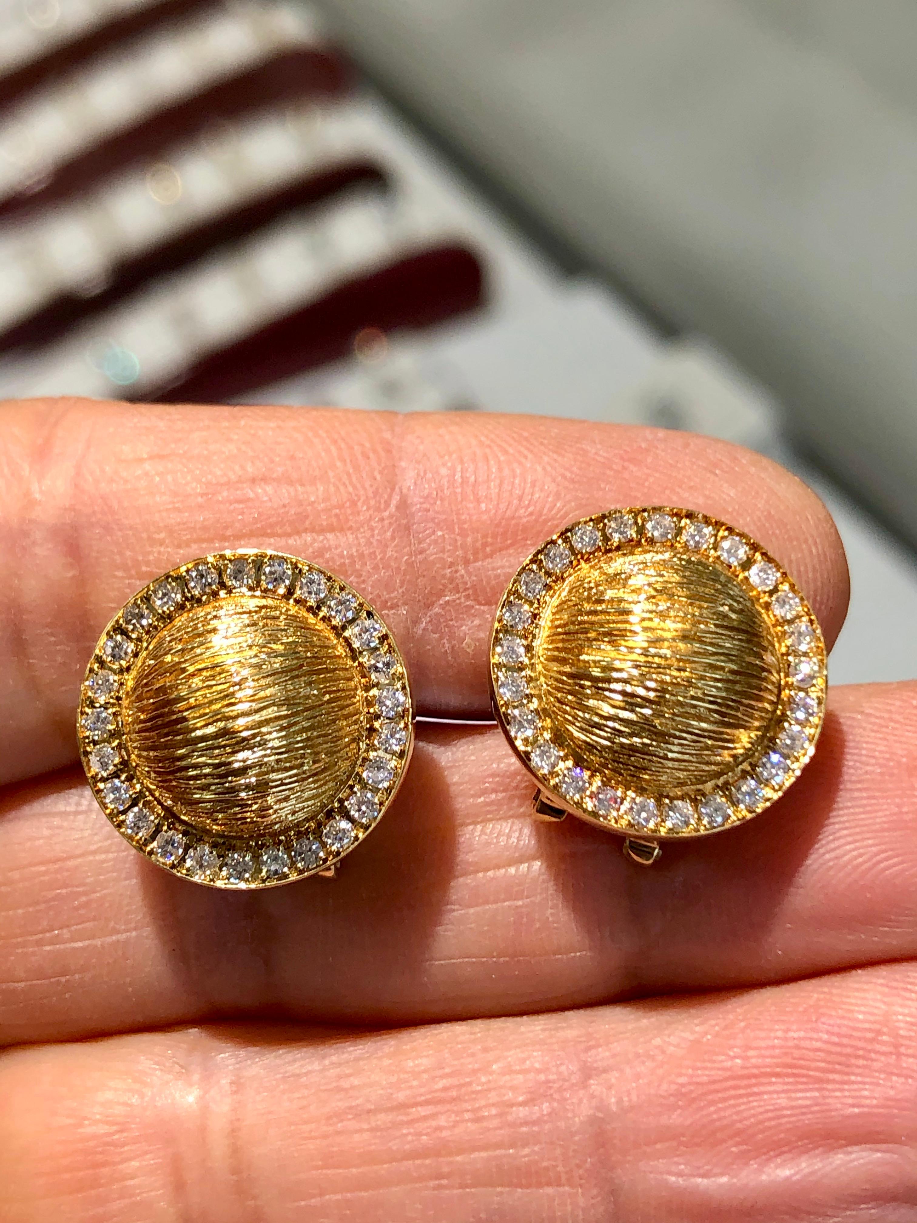 A stylish estate pair of button earrings, featuring a stunning textured 18K yellow gold. They are set with round brilliant cut diamonds, weighing a combined 1.00 carats (F-G color and VS clarity). Clip backs can be converted to posts.
The earrings